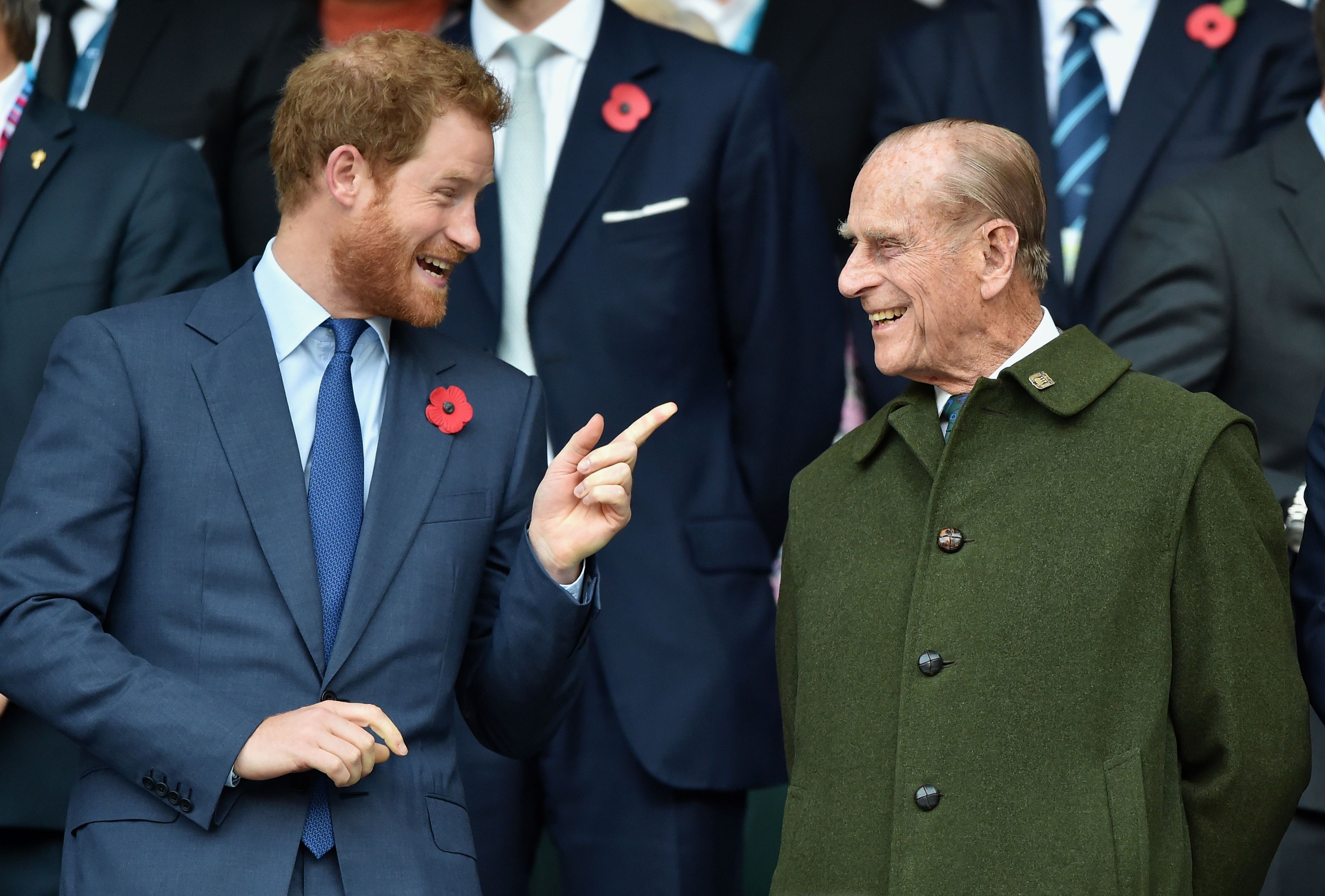 Prince Harry and Prince Philip, Duke of Edinburgh chatting at the 2015 Rugby World Cup Final match between New Zealand and Australia at Twickenham Stadium in London, England | Photo: Getty Images