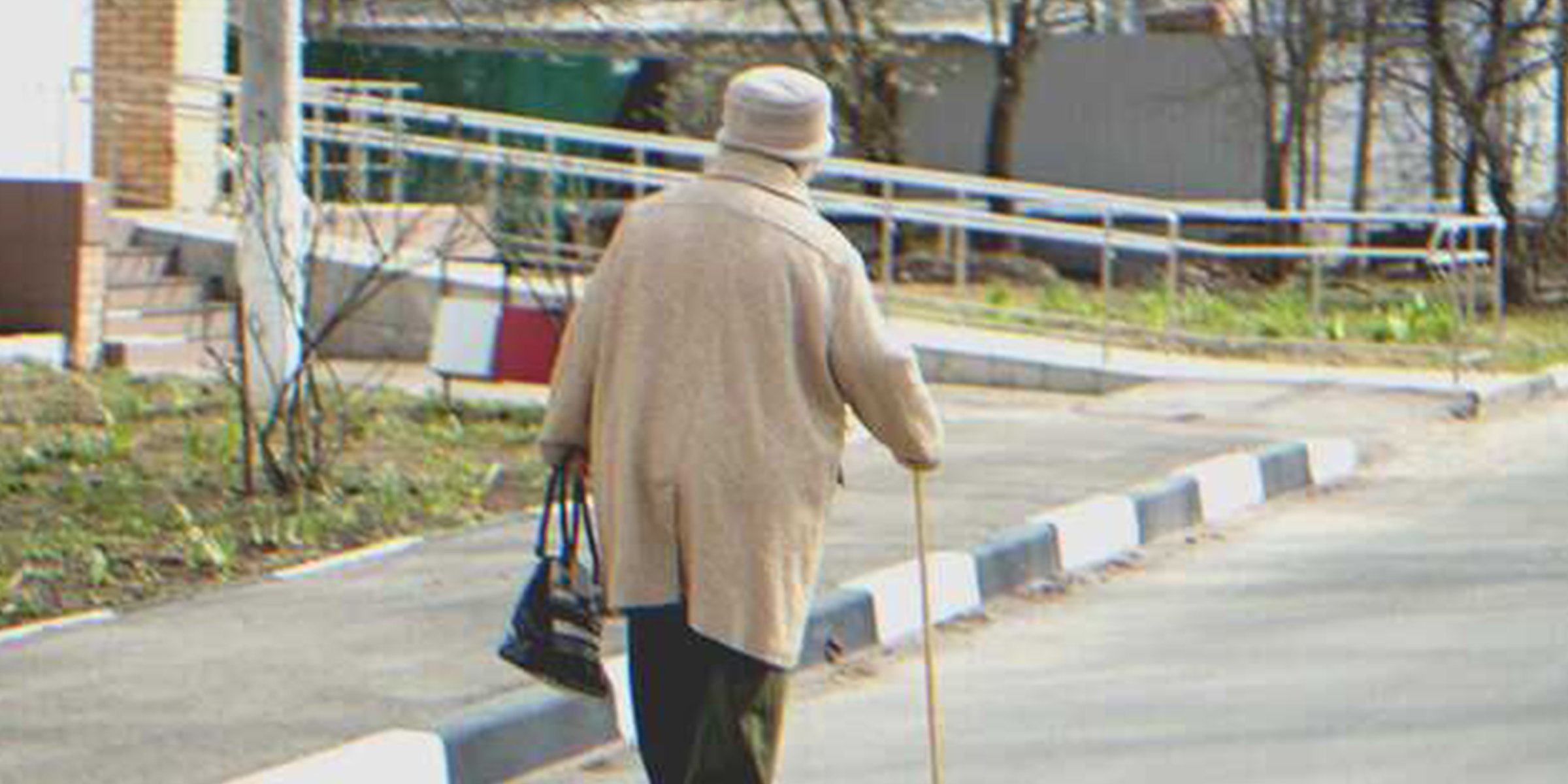 An old lady walking down the street | Source: Shutterstock