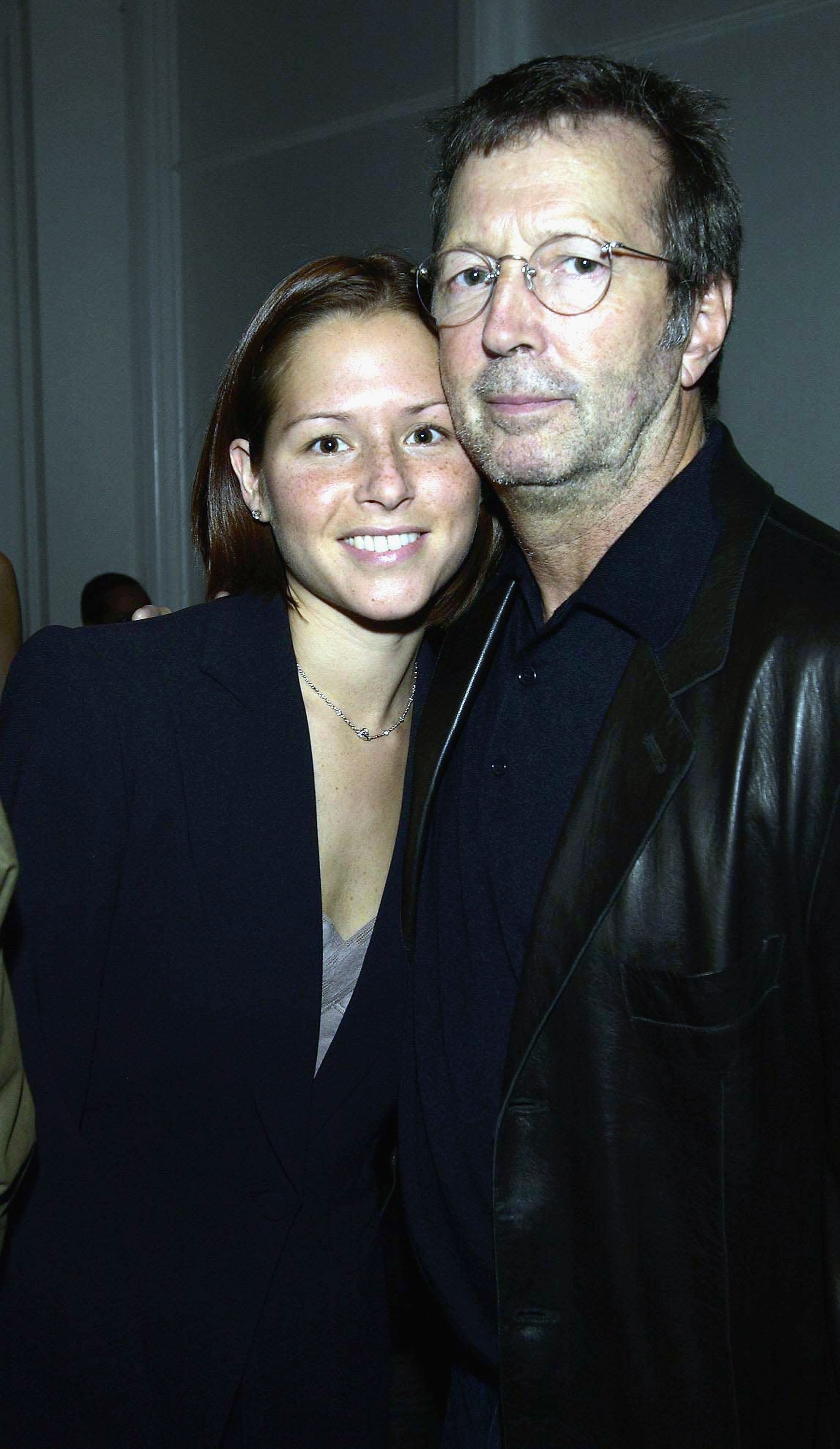 Eric Clapton and Melia McEnery at the "Giorgio Armani: A Retrospective" party on October 14, 2003, in London | Source: Getty Images