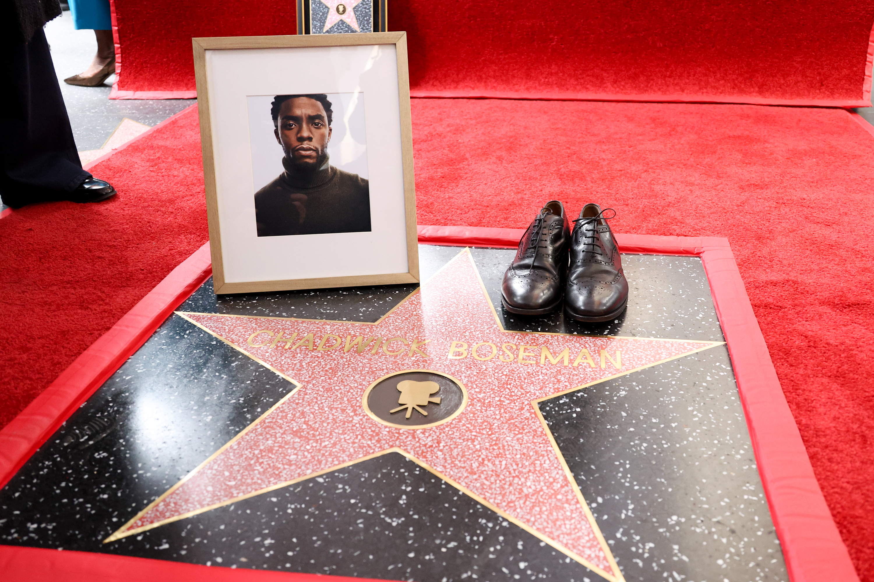 A picture of Chadwick Boseman and his shoes seen during the ceremony where he was honored with a Posthumous Star on the Hollywood Walk of Fame on November 20, 2025 | Source: Getty Images
