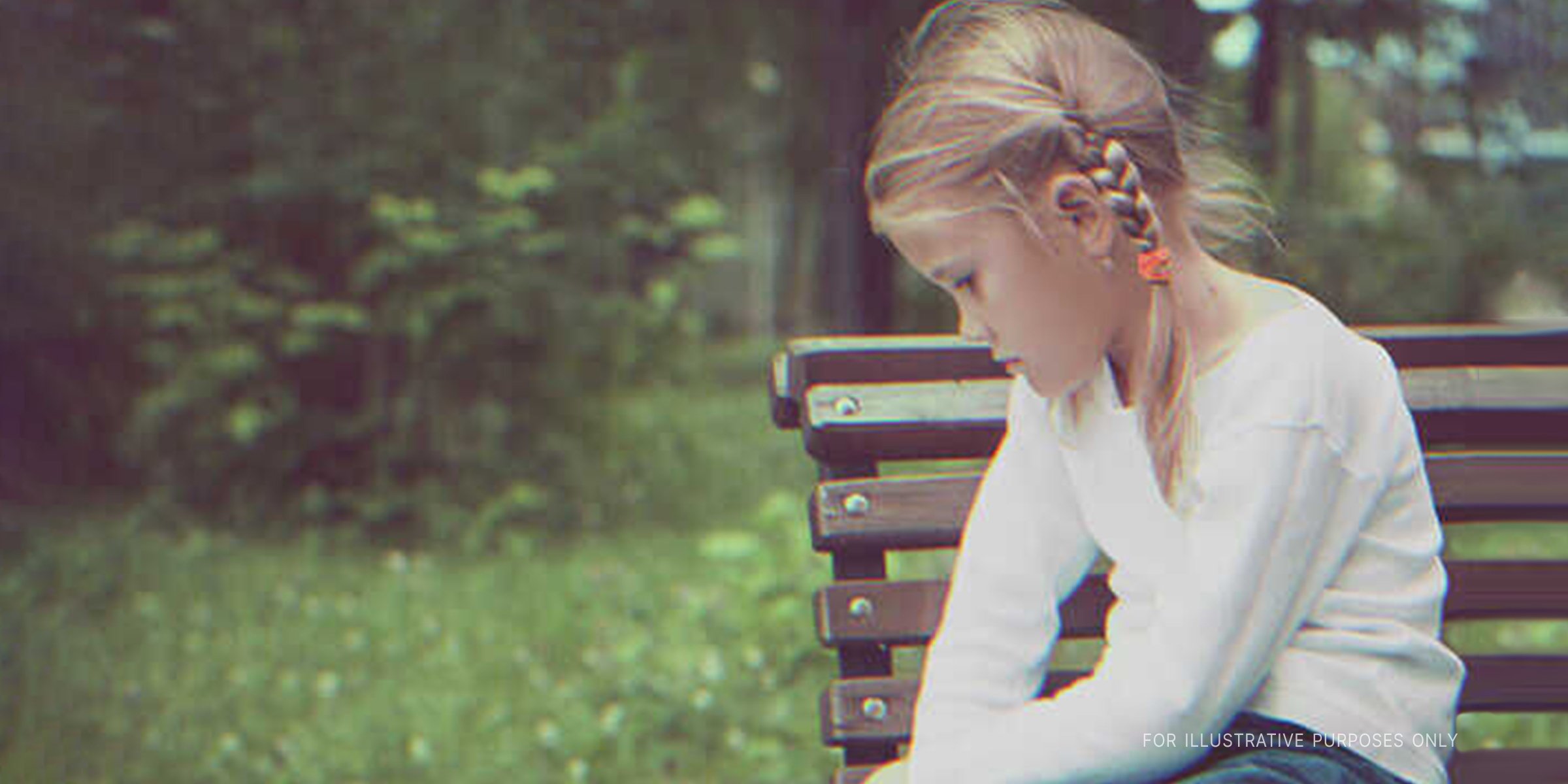 Sad Girl Sitting On A Bench. | Source: Shutterstock