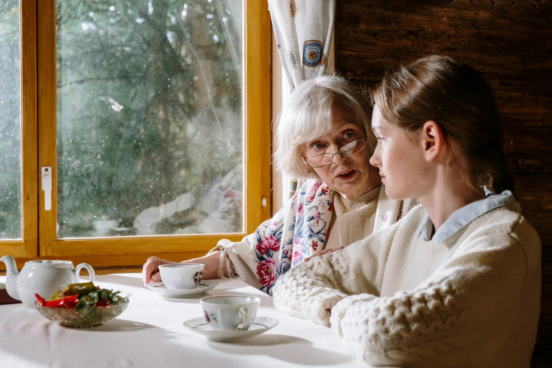 A young woman drinking tea with an elderly woman | Source: Pexels