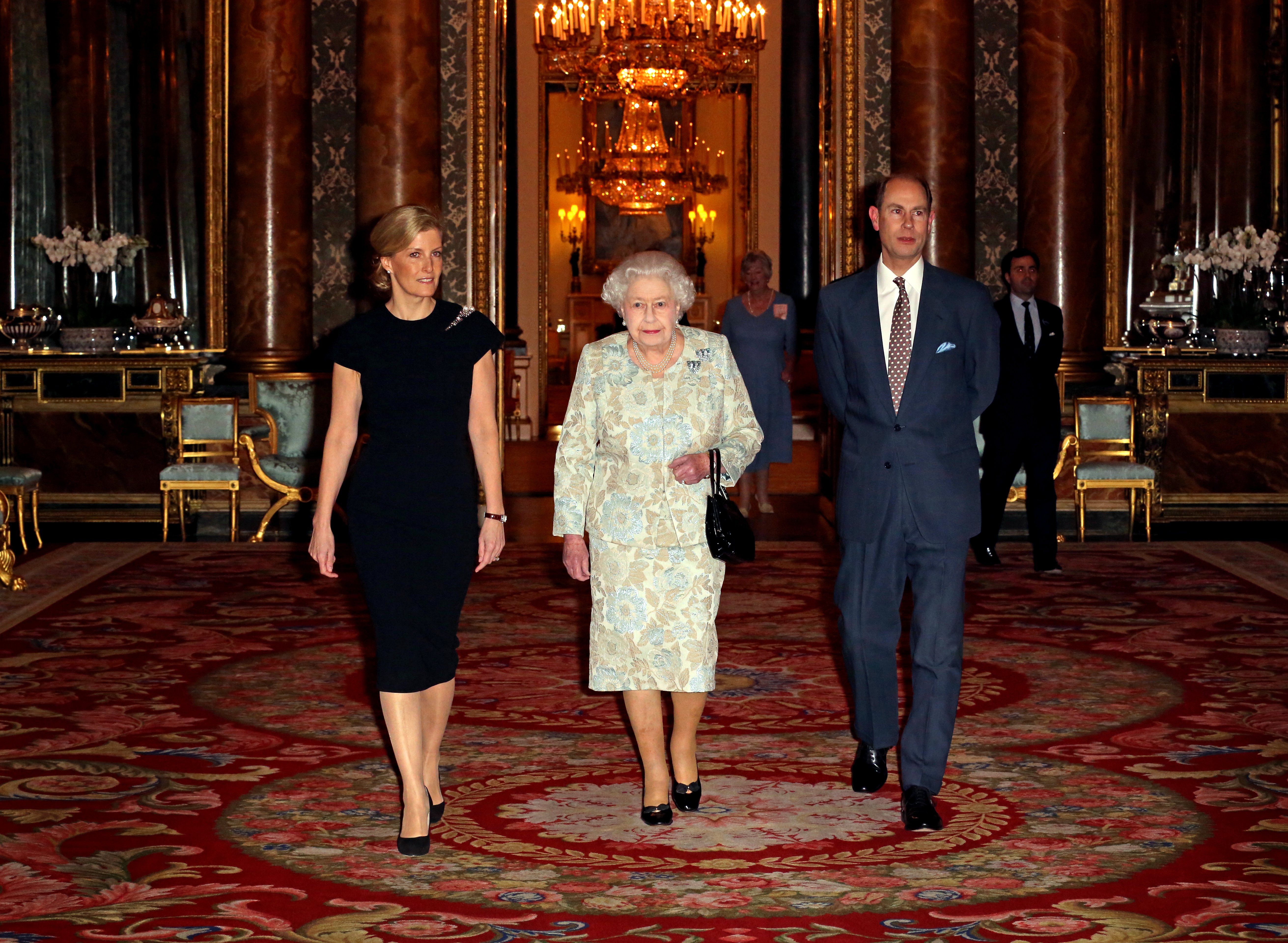 Queen Elizabeth II (R) with Sophie, Countess of Wessex (L) and Prince Edward, Earl of Wessex during her reception to celebrate the patronages & affiliations of the Earl and Countess of Wessex at Buckingham Palace on February 10, 2015 in London, England | Source: Getty Images 