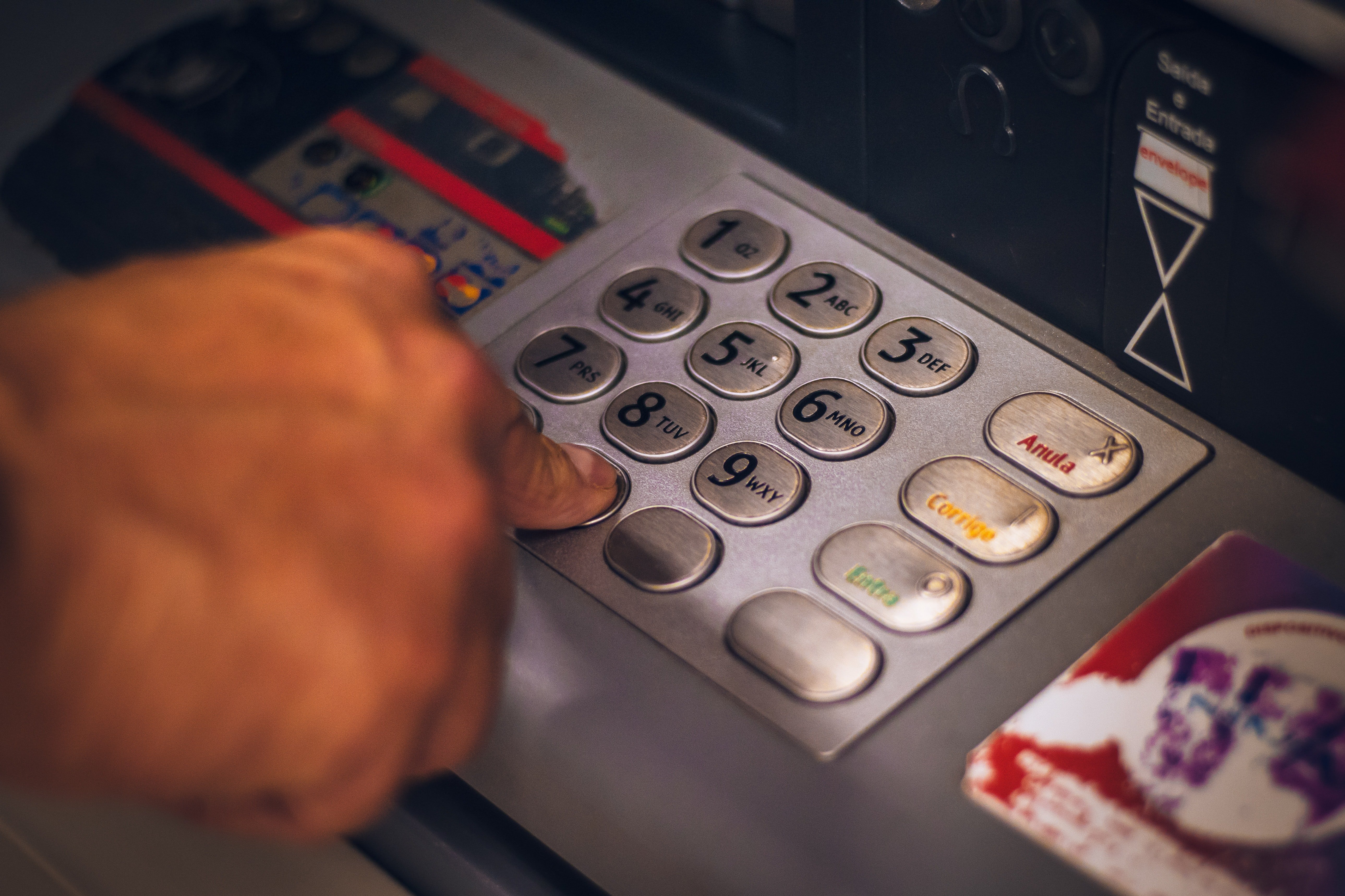 A customer withdrawing money at an ATM | Source: Pexels