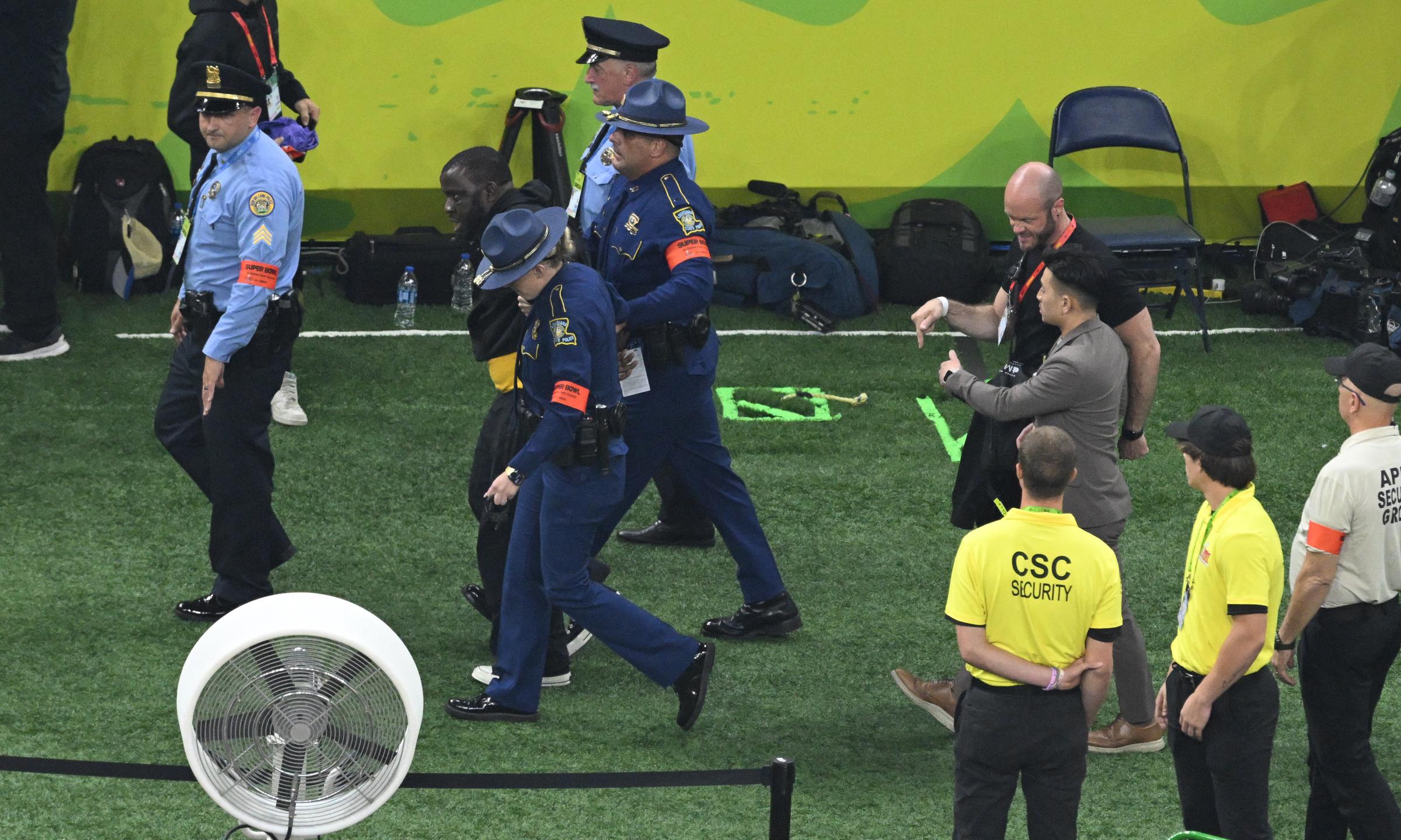 Security escorts out Nantambu as Kendrick Lamar performs on February 9, 2025 | Source: Getty Images