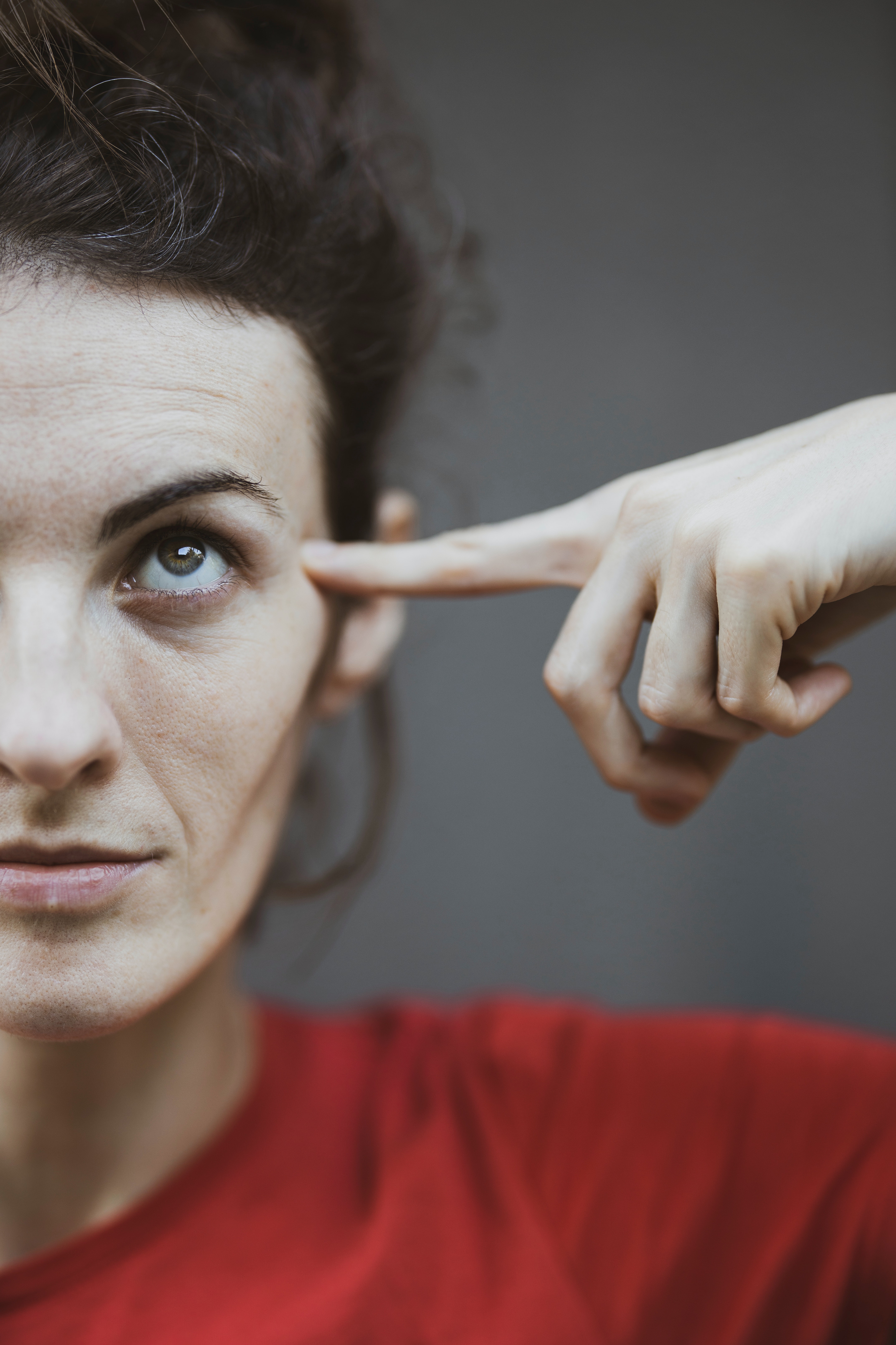 Woman pointing to her head | Source: Pexels