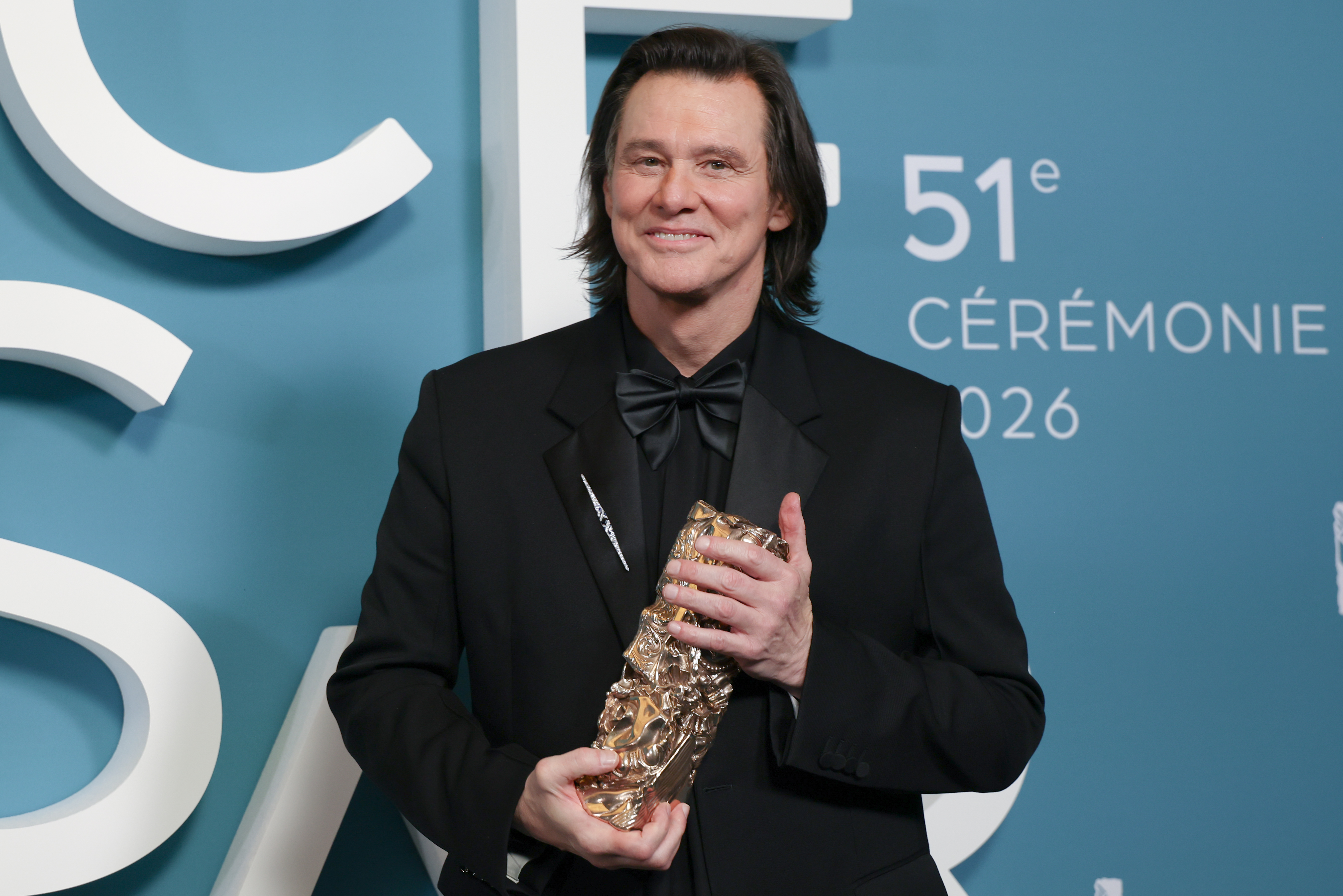 Jim Carrey posing with his Honorary Cesar Award during the 51st Cesar Film Awards. | Source: Getty Images