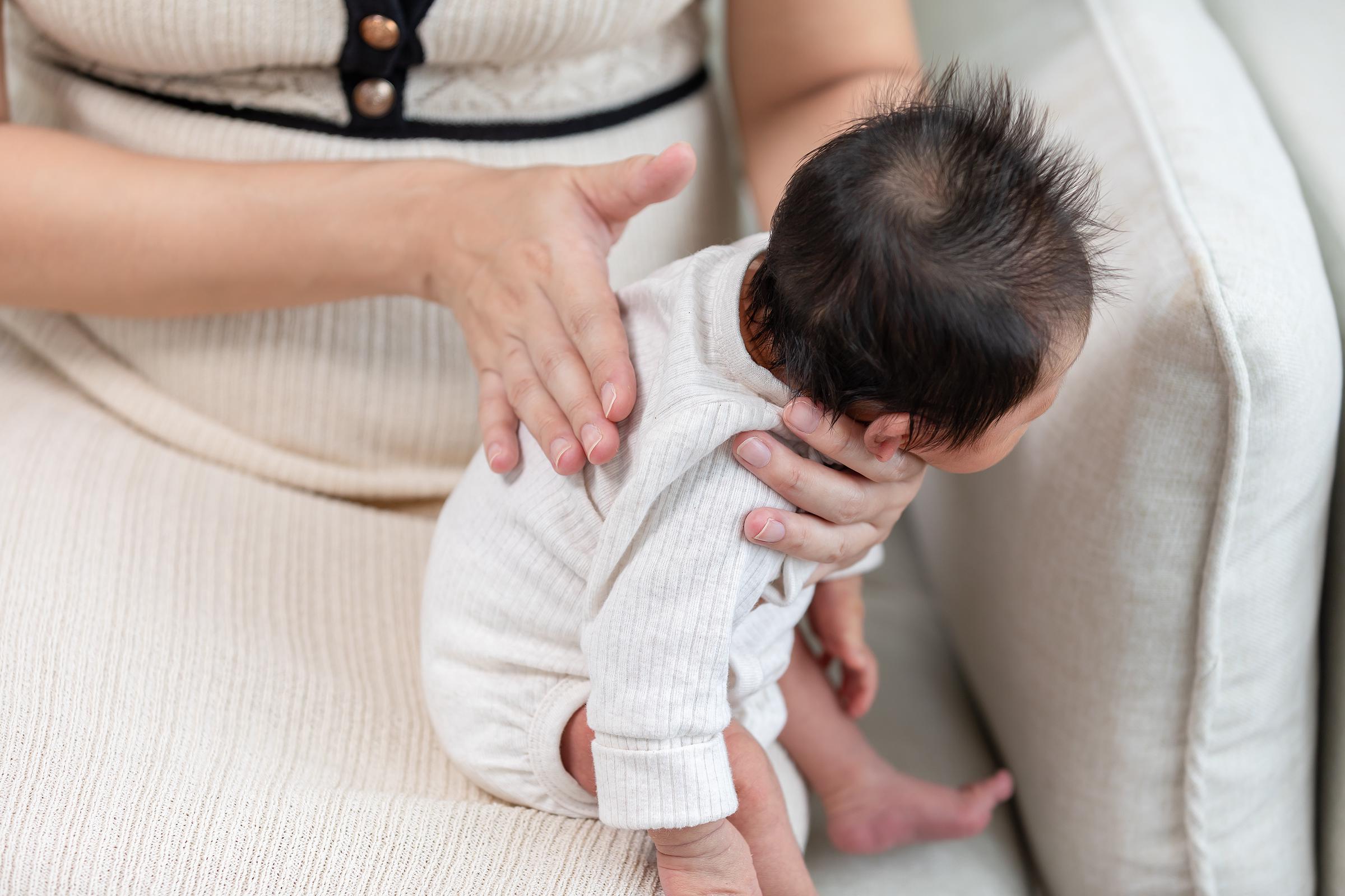 A mom helping ease her baby's hiccups | Source: Getty Images