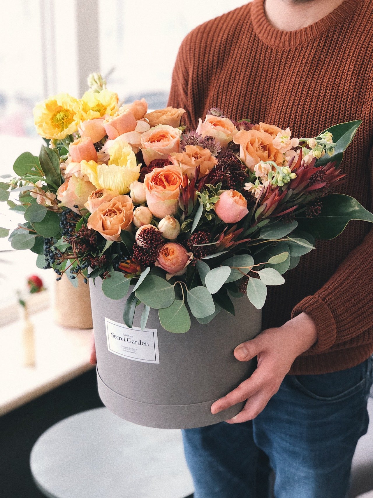 Woman holding orange tulips bouquet | Source: Pexels