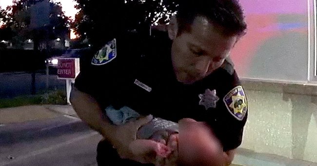 Officer Garcia rescuing an infant outside In N Out. | Source:  facebook.com/mountainviewpolicedepartment