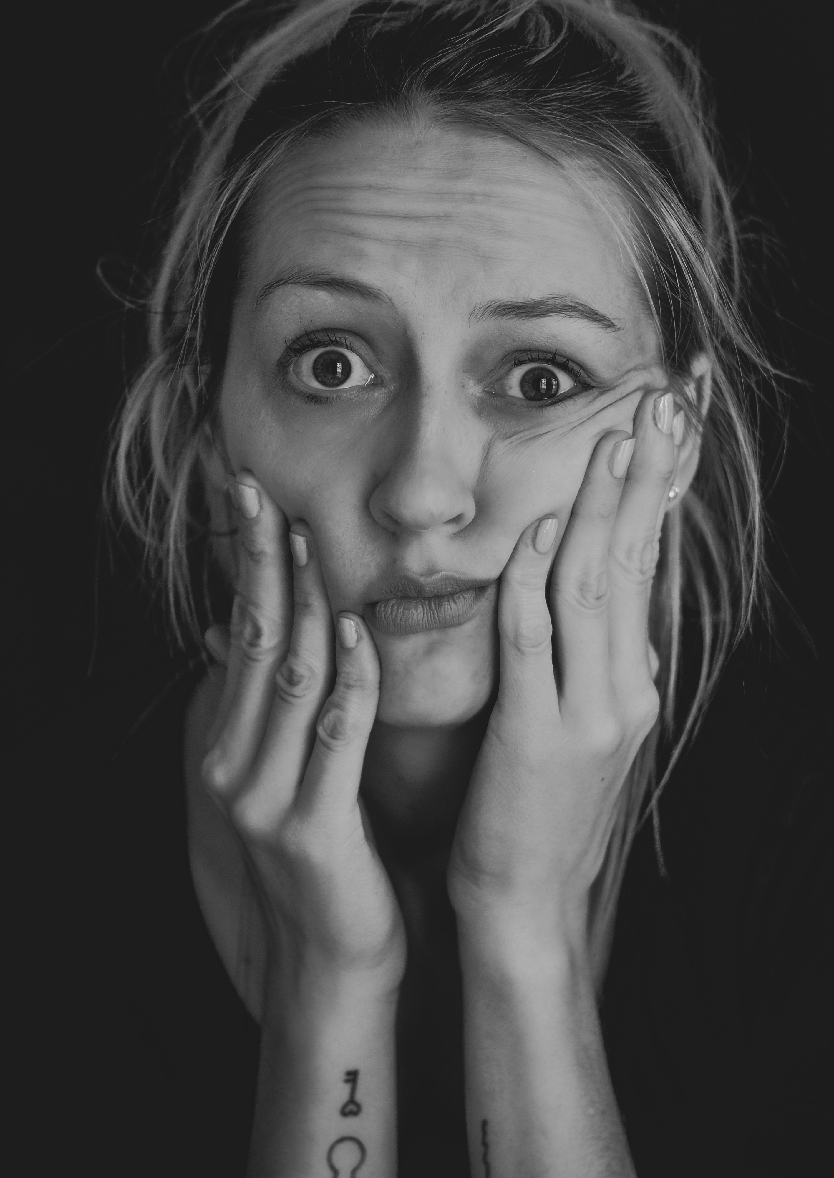 A black and white shot of a shocked woman | Source: Unsplash