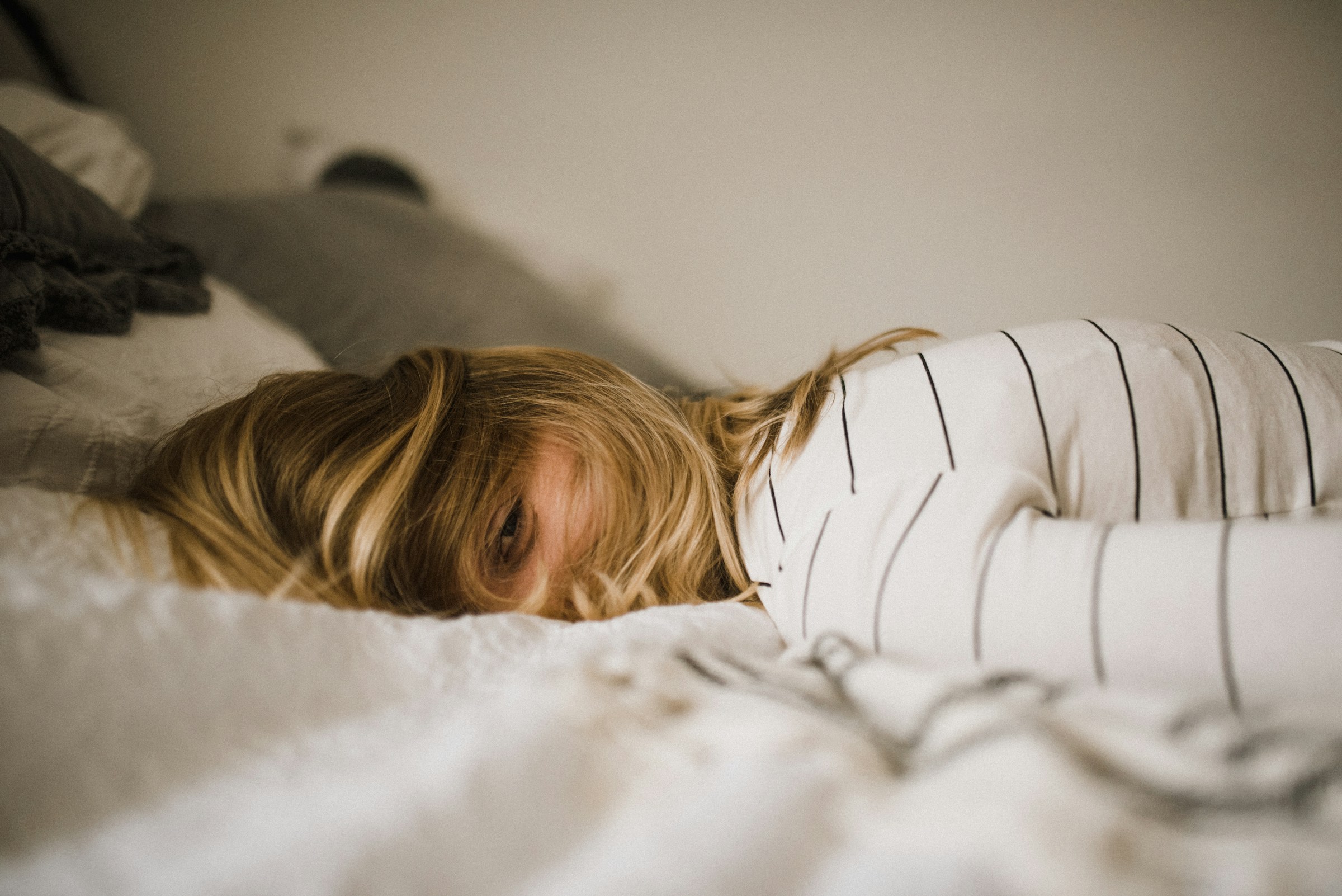 A woman lying on bed | Source: Unsplash