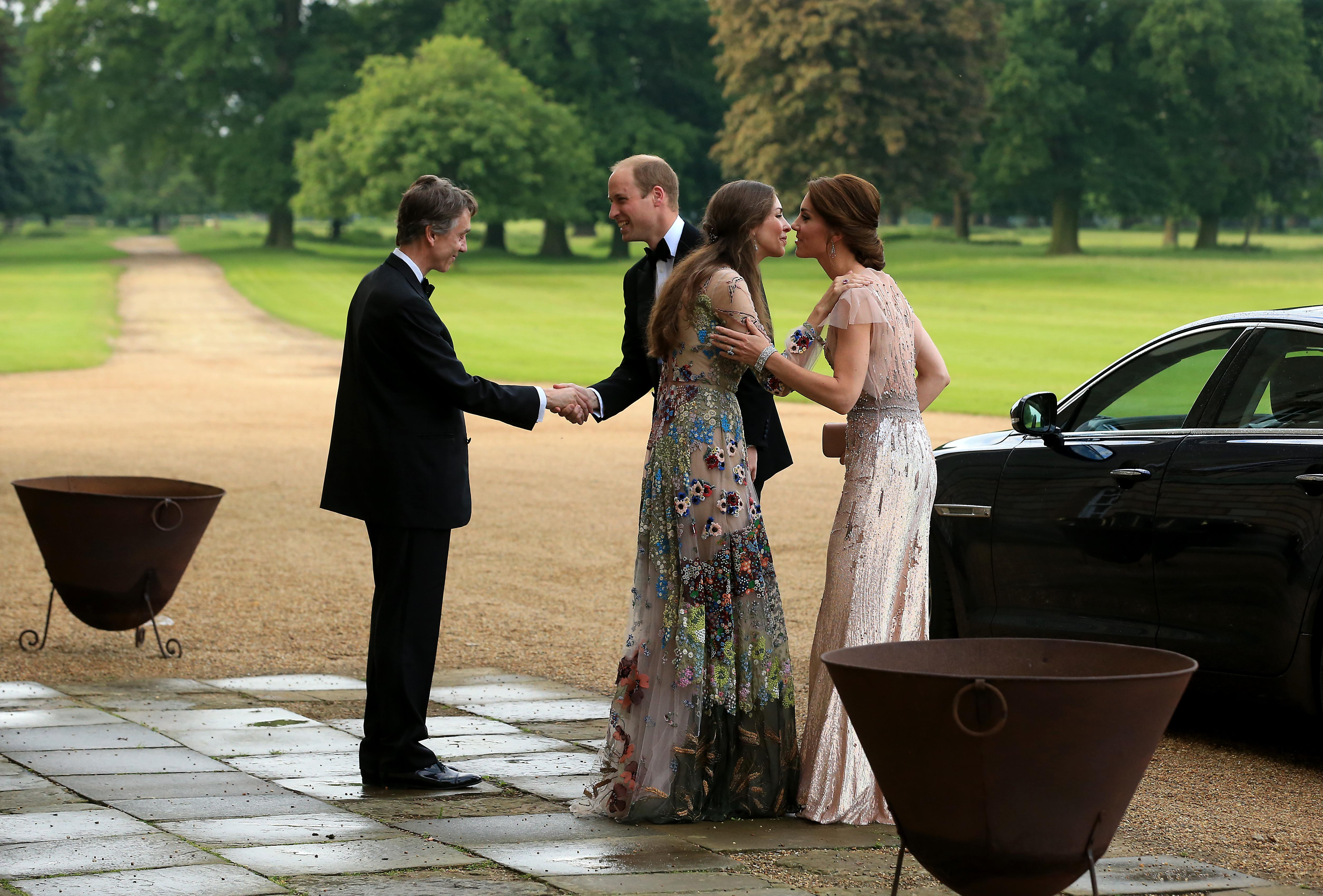 Prince William and Catherine, Duchess of Cambridge are greeted by David Cholmondeley, Marquess of Cholmondeley and Rose Cholmondeley, the Marchioness of Cholmondeley at a gala dinner on June 22, 2016 in King's Lynn, England | Source: Getty Images
