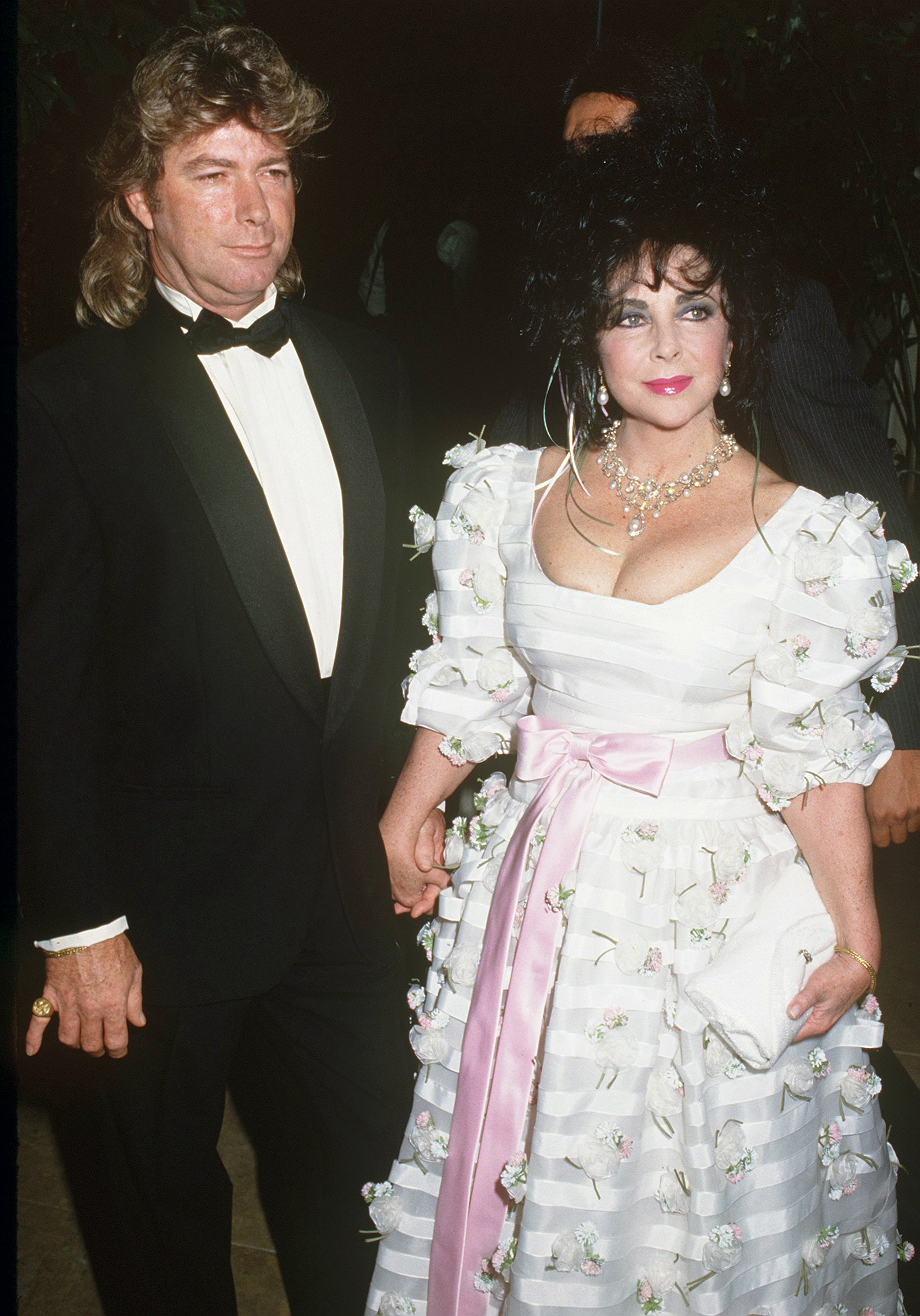 Actress Elizabeth Taylor (1932 - 2011) and her husband Larry Fortensky (1952 - 2016) attending the Carousel of Hope at the Beverly Hilton Hotel, USA, 16th May 1992. | Source: Getty Images