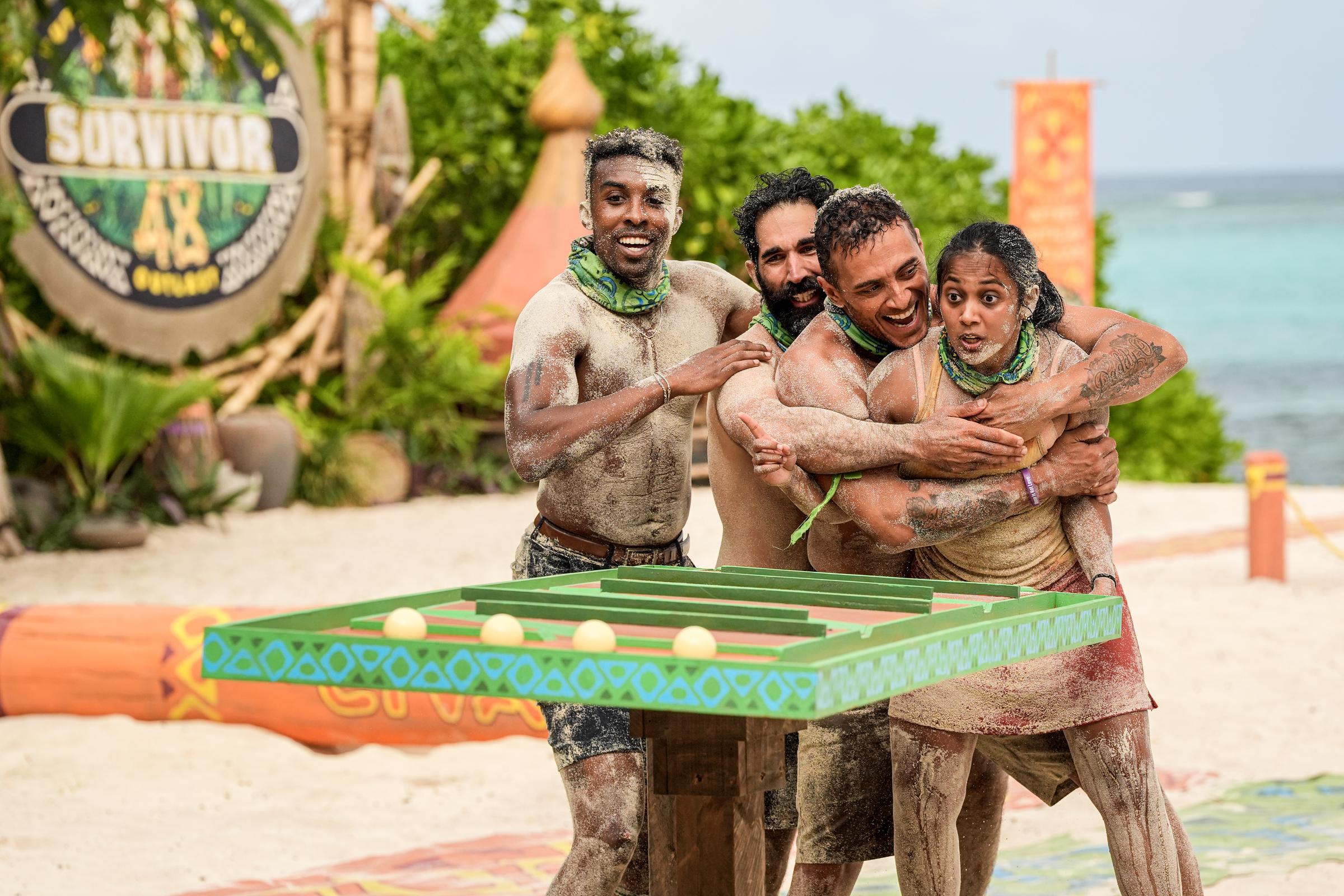 Kyle Fraser, Shauhin Davari, Joe Hunter, and Kamilla Karthigesu celebrate during an intense team challenge on the beach, on "Survivor" aired March 26, 2025 | Source: Getty Images