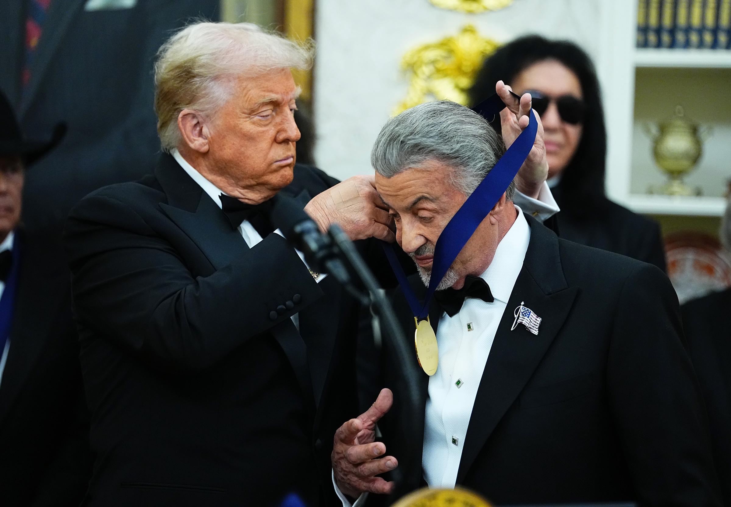 U.S. President Donald Trump presents actor Sylvester Stallone with a medal for the 2025 Kennedy Center Honorees