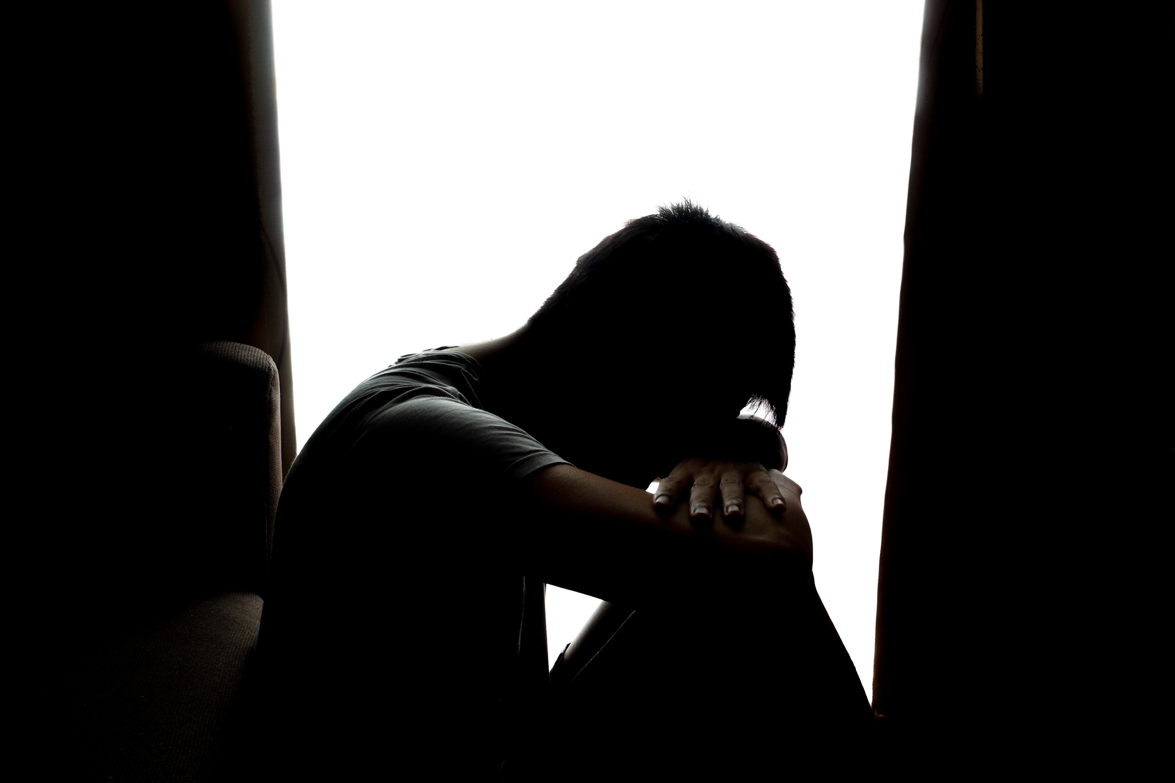 A silhouette of a sad young boy. │Source: Shutterstock 