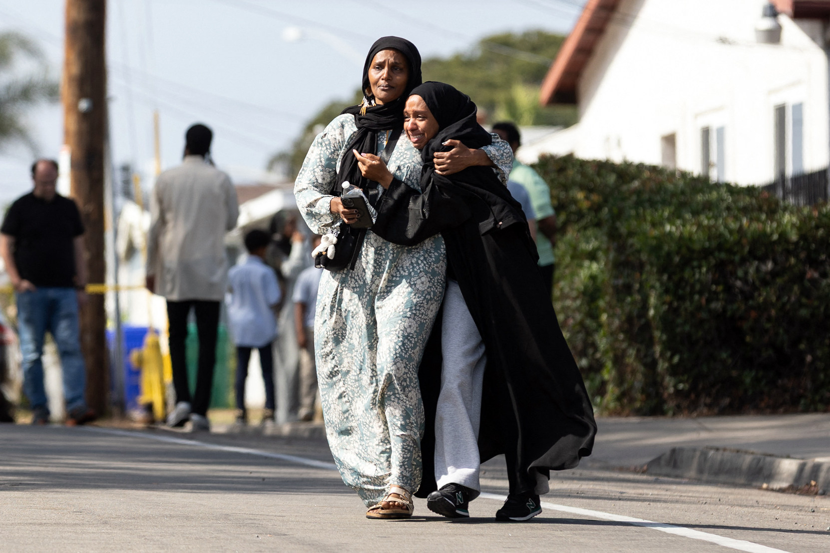 Community members leave a reunification center following the shooting in San Diego on May 18, 2026 | Source: Getty Images