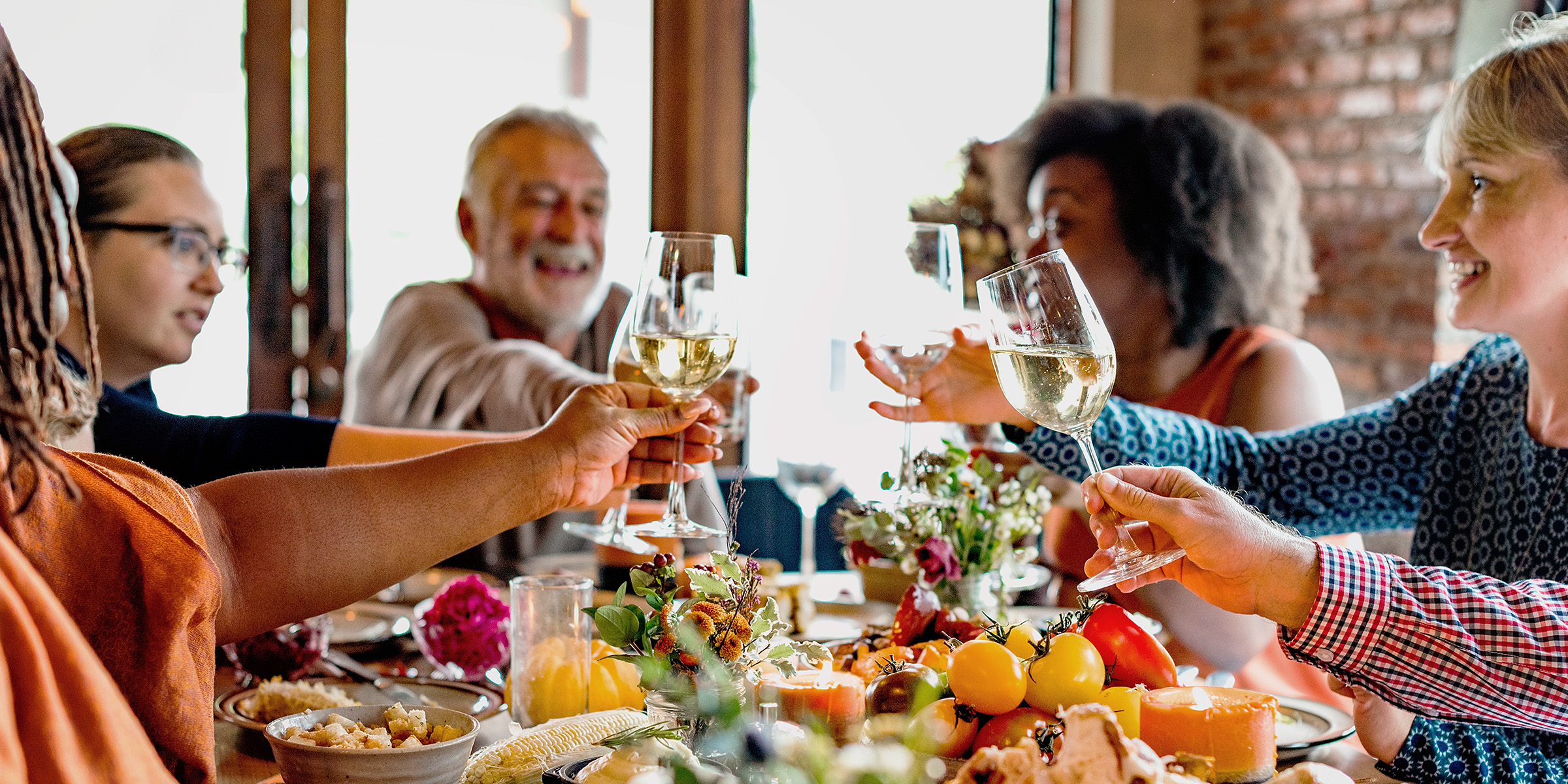 A family toasting while having dinner | Source: Shutterstock