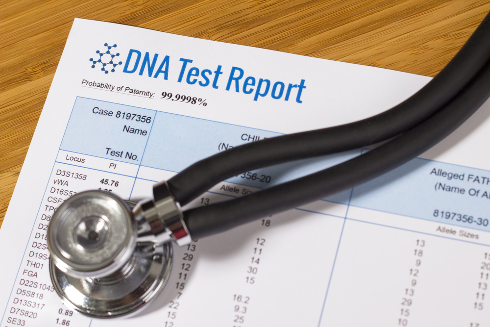 A DNA test report under a stethoscope | Shutterstock