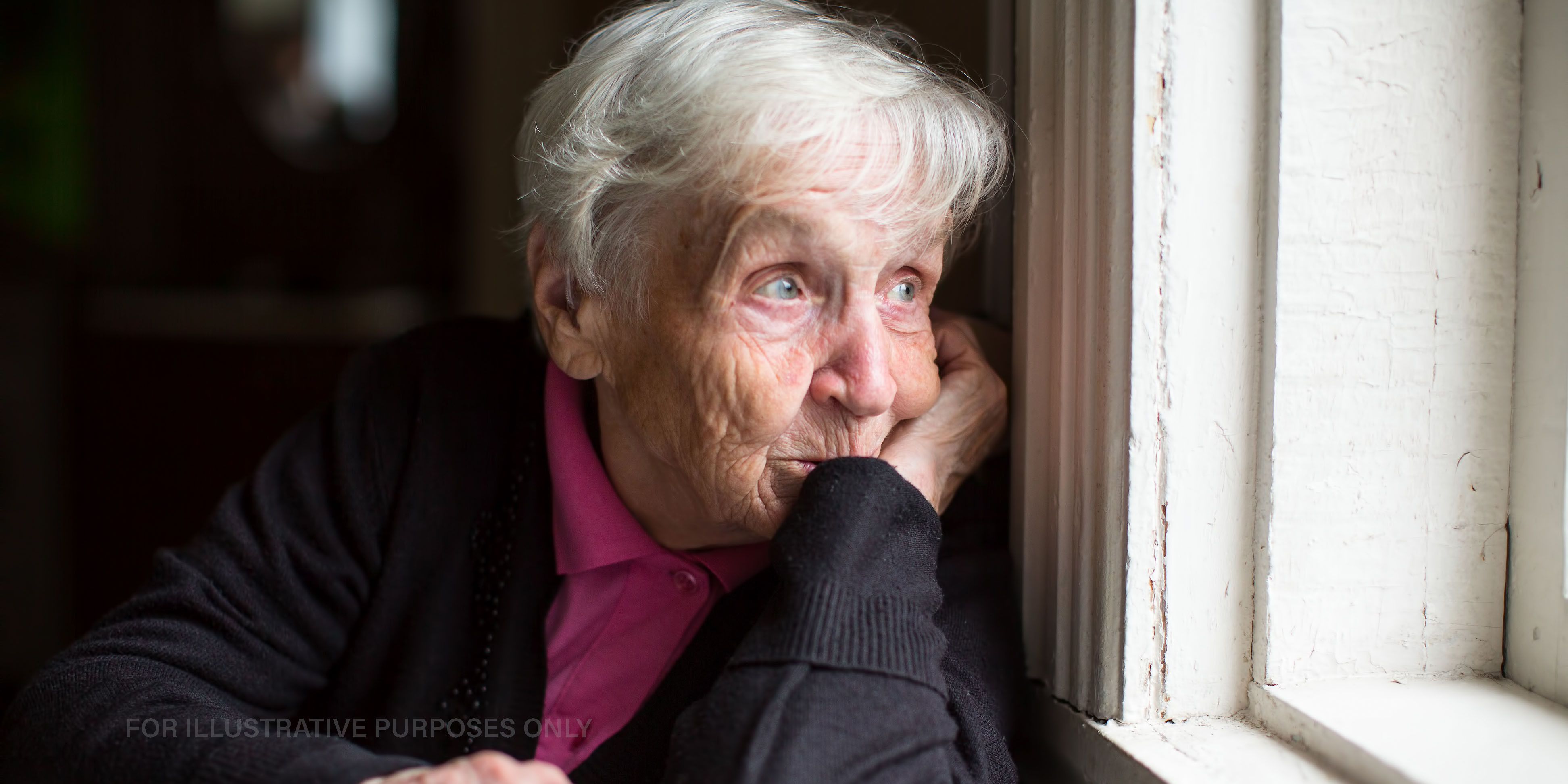 Older woman sitting by the window | Source: Shutterstock