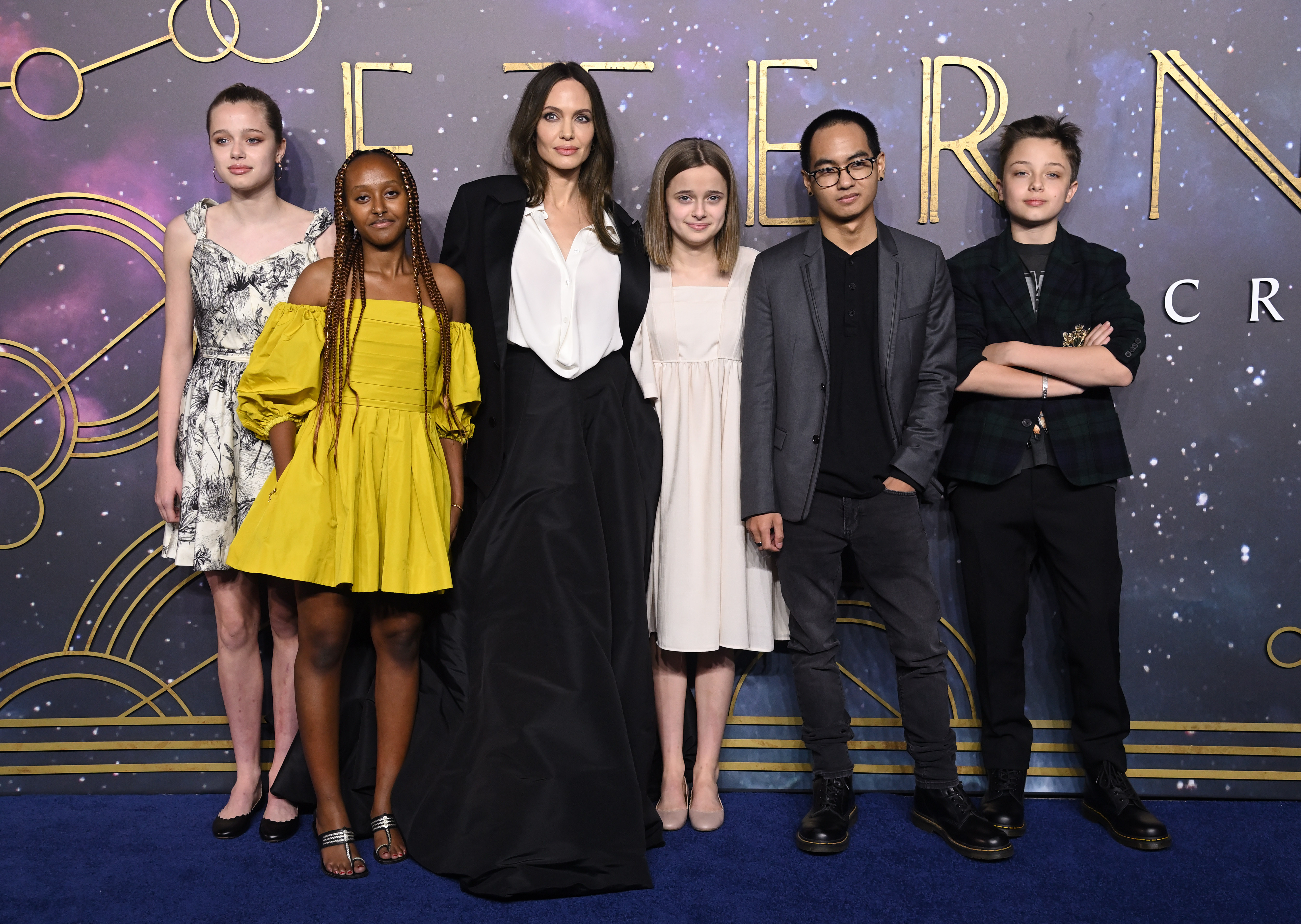Angelina Jolie poses with five of her six children at a red carpet event. The actress said watching her children grow into young adults has inspired her to rediscover parts of herself beyond motherhood and embrace a new chapter in life. | Source: Getty Images