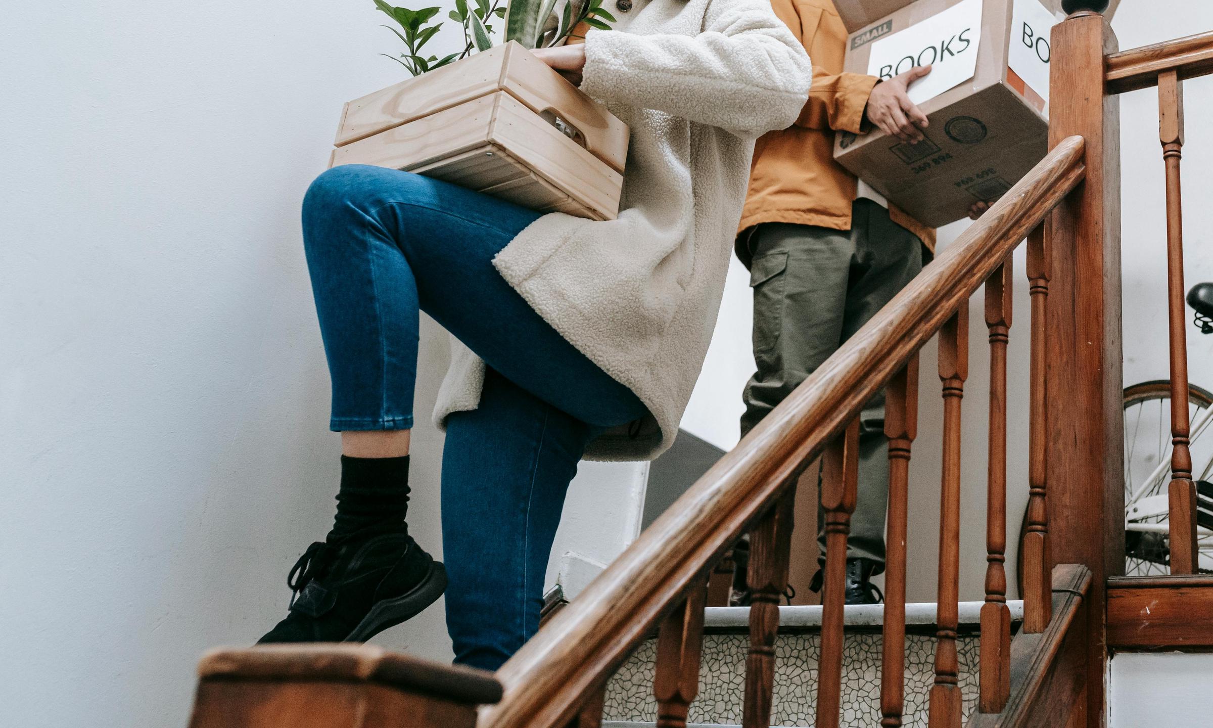 Packed items being carried down stairs | Source: Pexels
