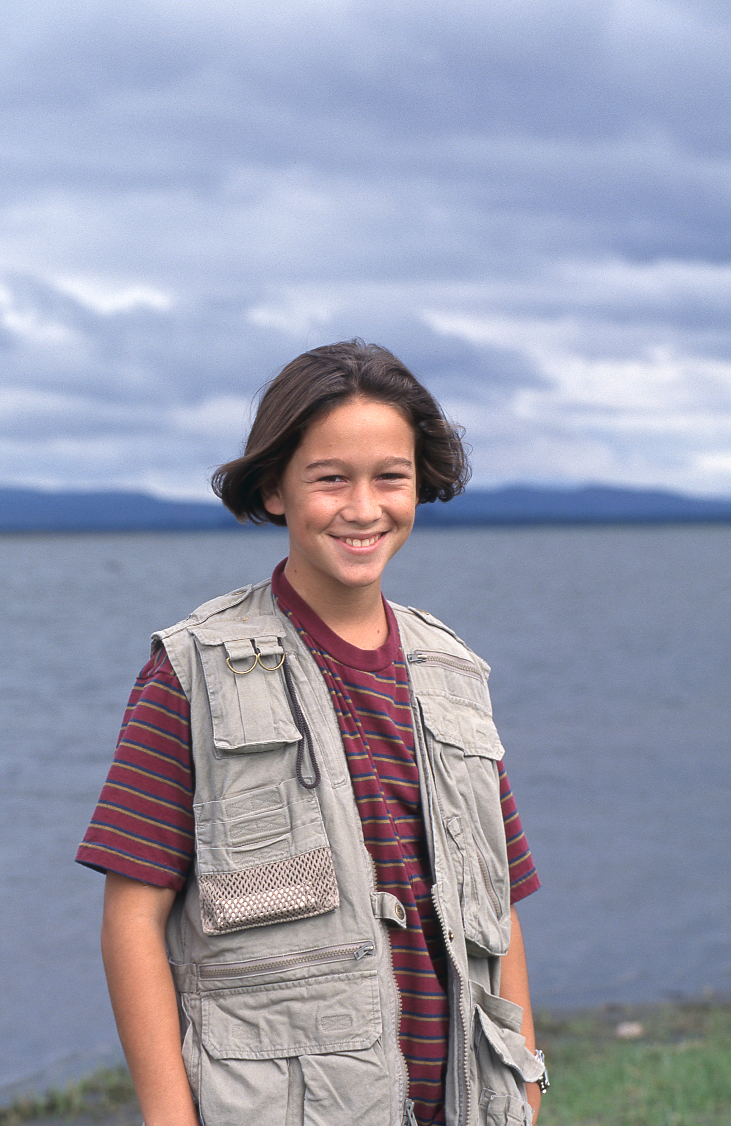 In 1994, Gordon-Levitt was all charm and boyish energy with his signature long hair, striped tee, and oversized utility vest. Just 13 at the time, he was beginning to land steady acting work, including his role in "Angels in the Outfield," which introduced him to a wider audience and showcased his early talent.
