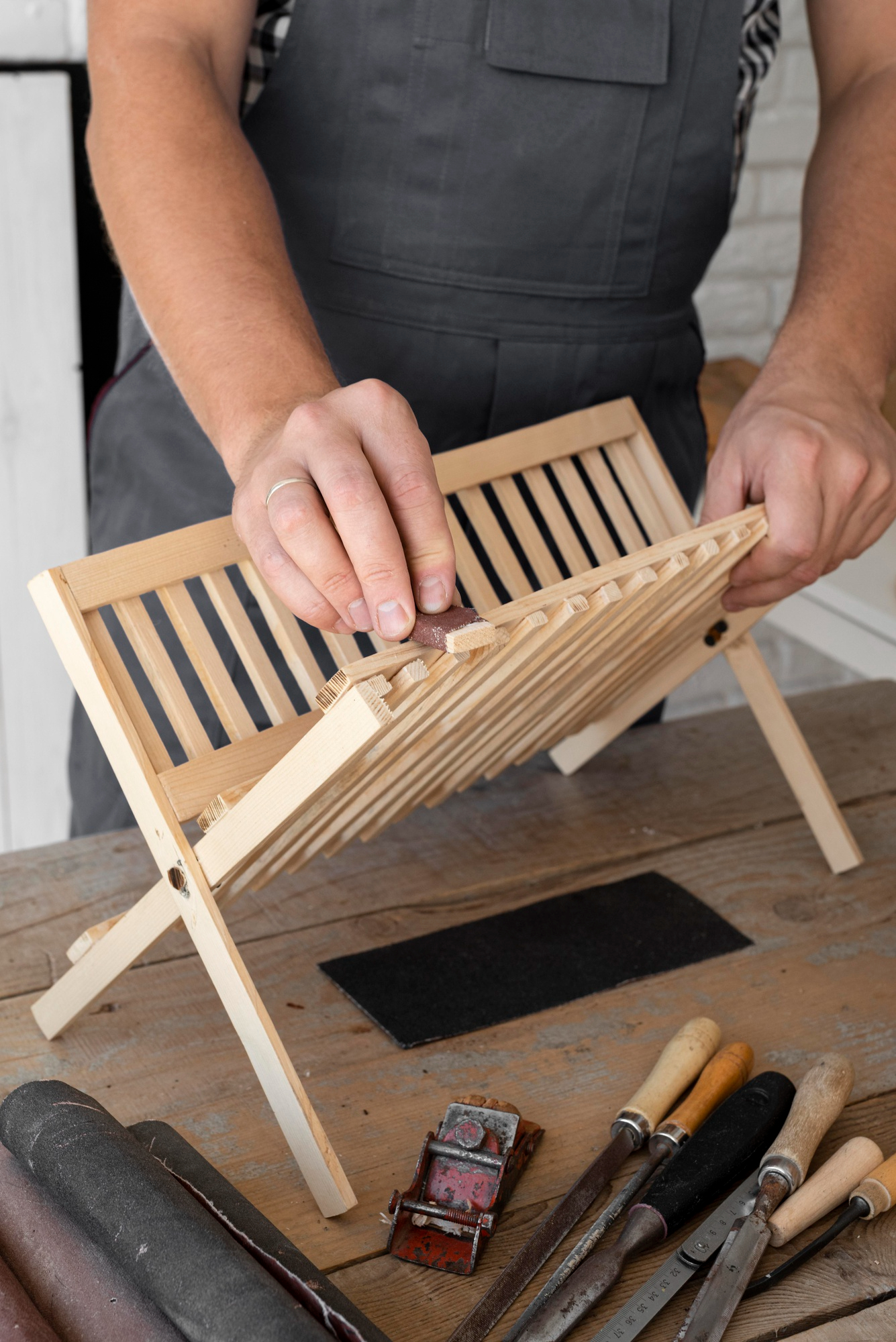 A man working on a wooden project | Source: Freepik