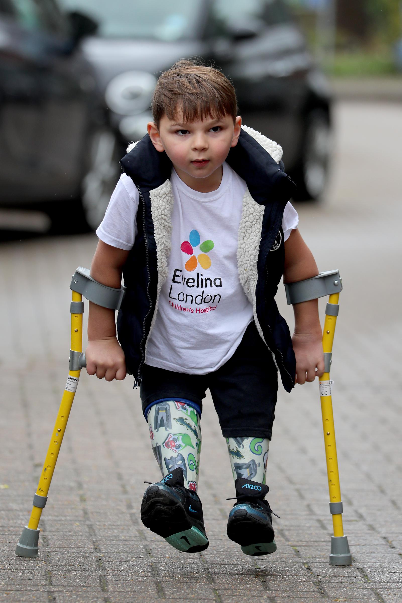 A determined five-year-old Tony Hudgell, wearing an Evelina London Children's Hospital t-shirt and supported by yellow forearm crutches, takes his final steps of his fundraising walk in West Malling, Kent, on 30 June 2020. Tony walked 10 kilometres throughout June, raising over £1 million for the hospital that had cared for him since he was four months old.