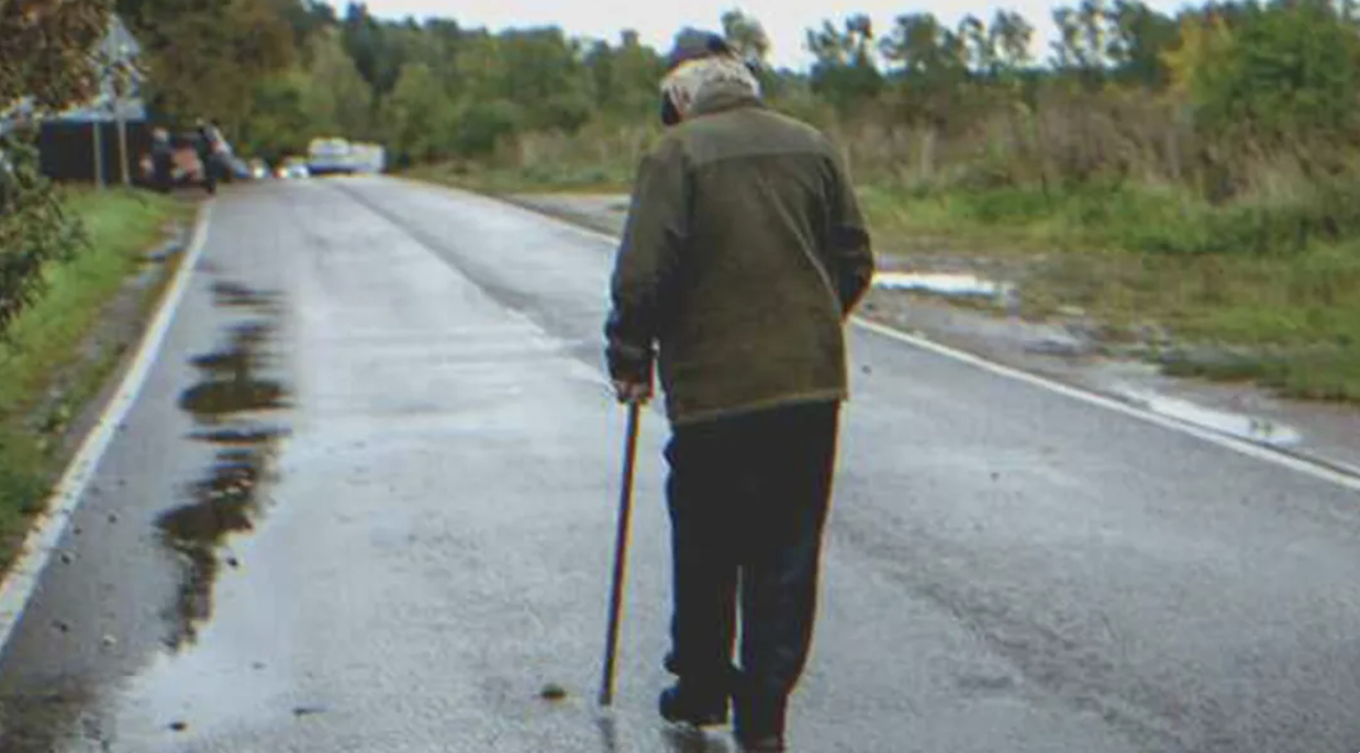 Lonely older man walking on the road | Source: Shutterstock