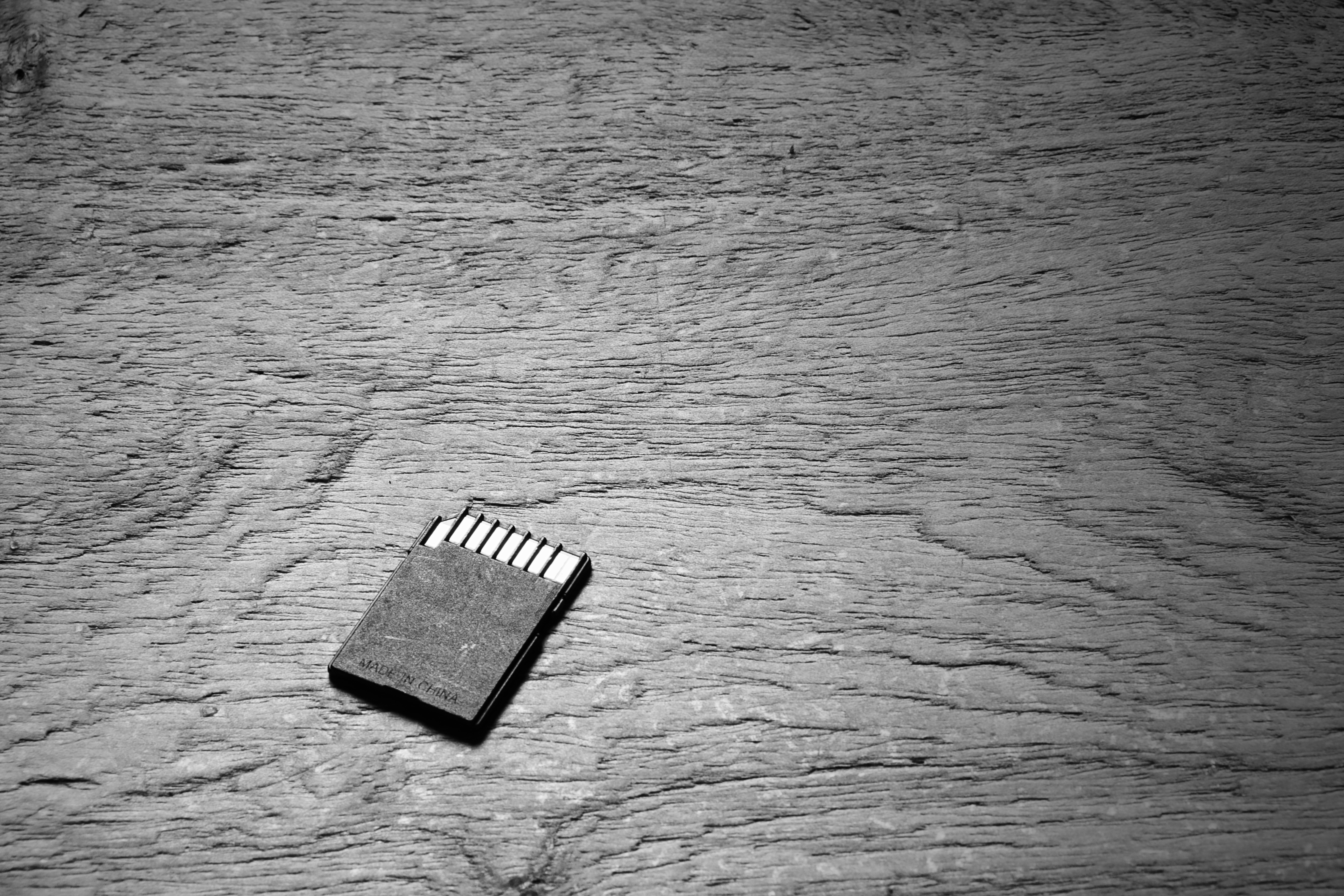 SD memory card on wooden floor. | Source: Shutterstock