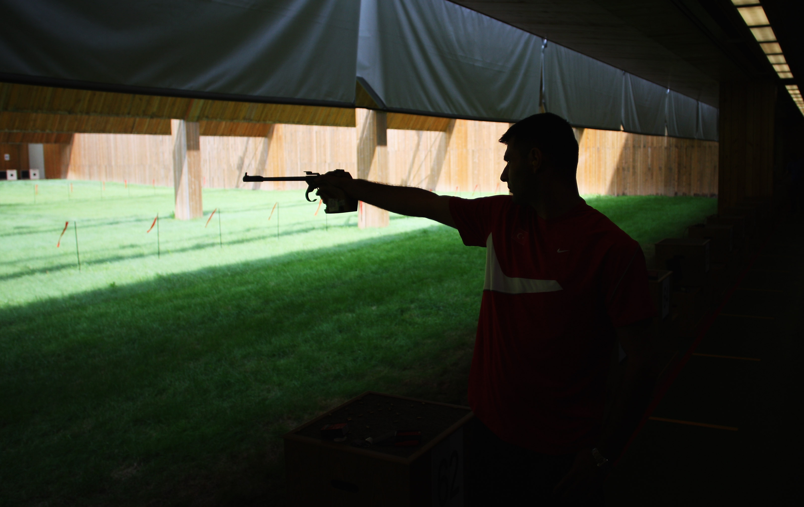 Turkey's former officer lines up his pistol on the 50m shooting range during a practice session ahead of the Beijing Olympic Games on August 1, 2008, in Beijing, China | Source: Getty Images