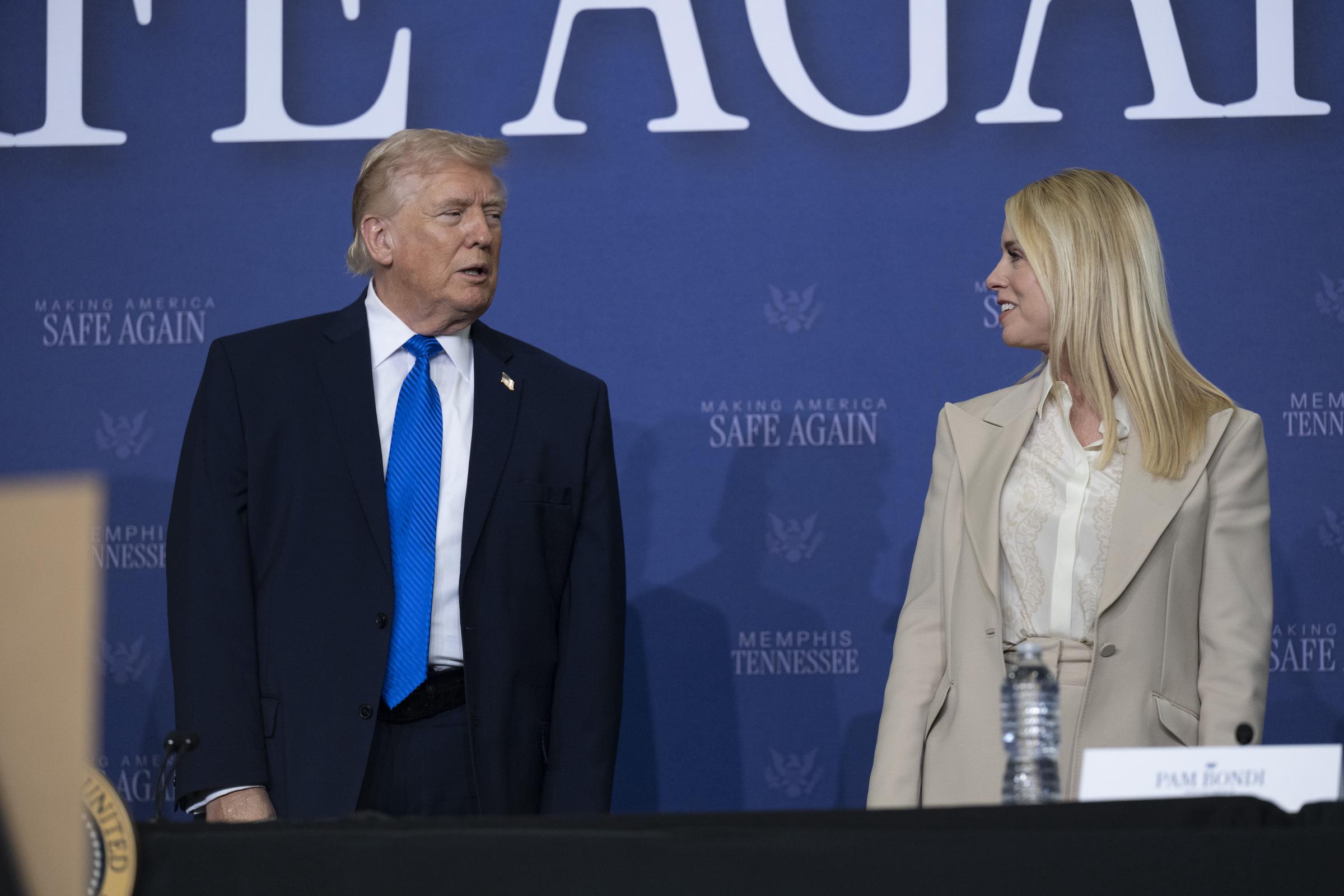 President Donald Trump interacts with Pam Bondi on March 23, 2026 in Memphis, Tennessee | Source: Getty Images