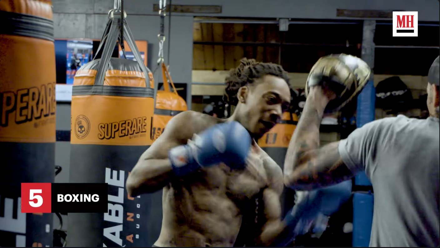 Wiz Khalifa works through boxing drills with a trainer during the combat-training portion of his workout routine. | Source: YouTube/Men's Health