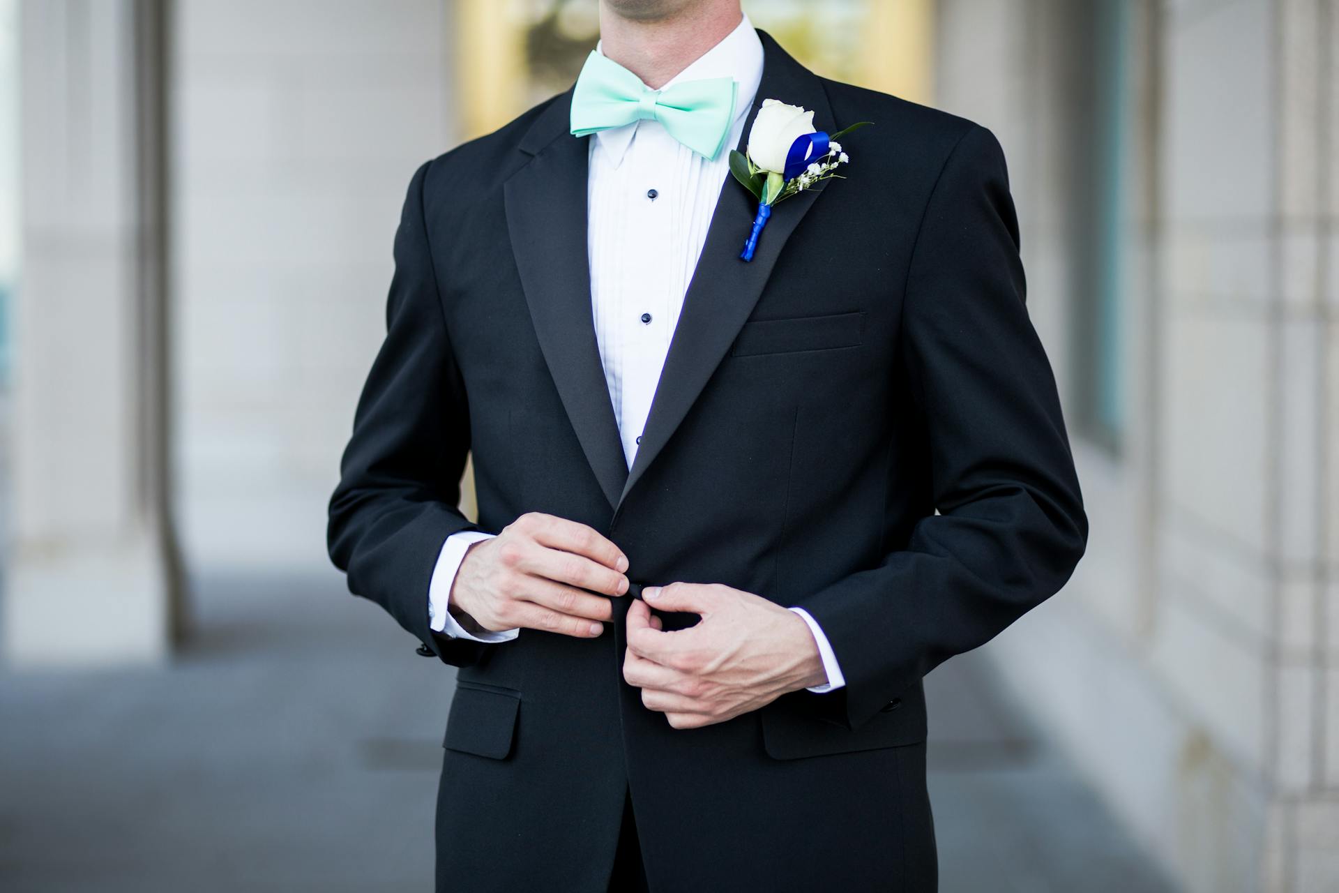 Close-up of a man in a black and teal tuxedo | Source: Pexels