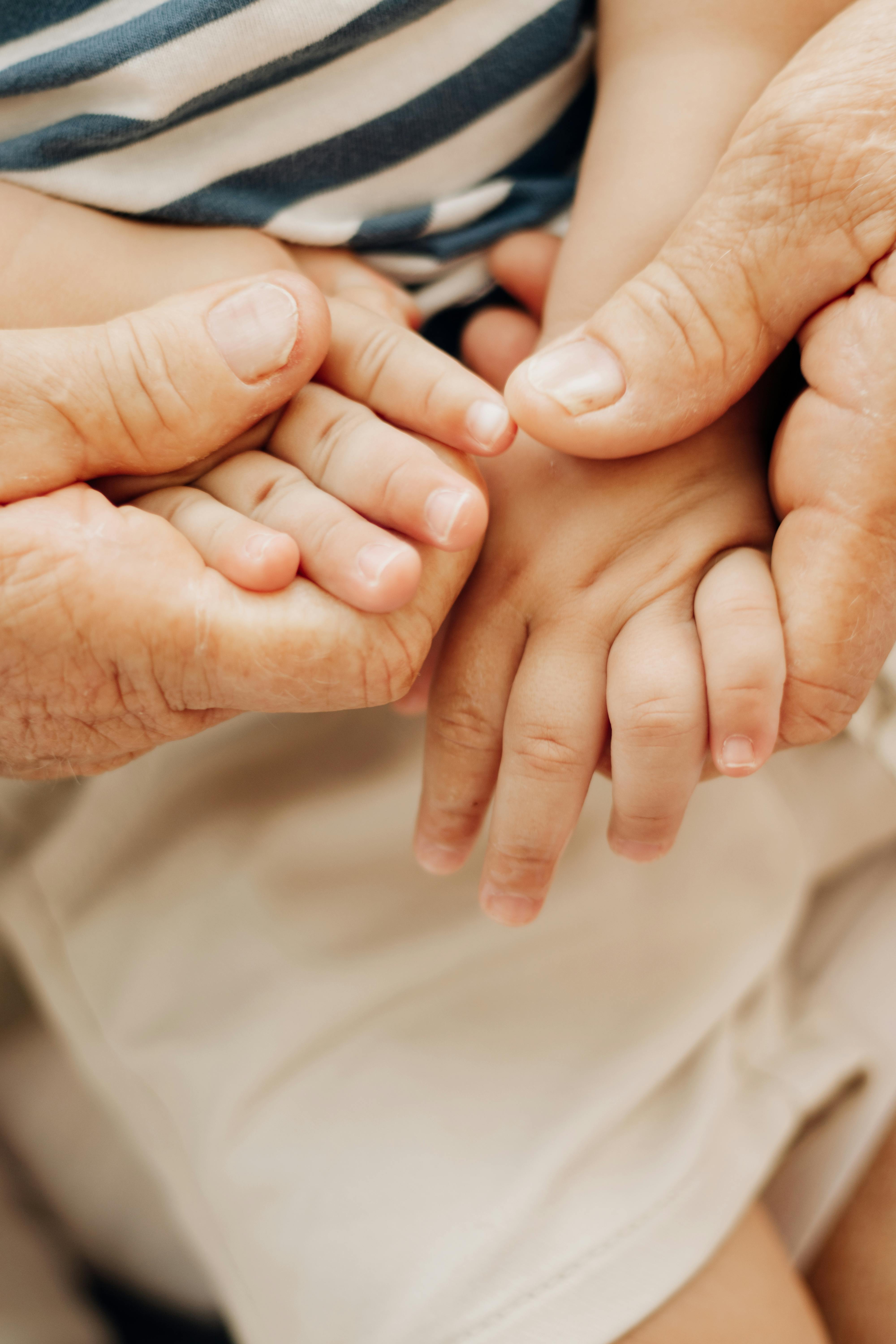 A woman's hands holding a baby's | Source: Pexels