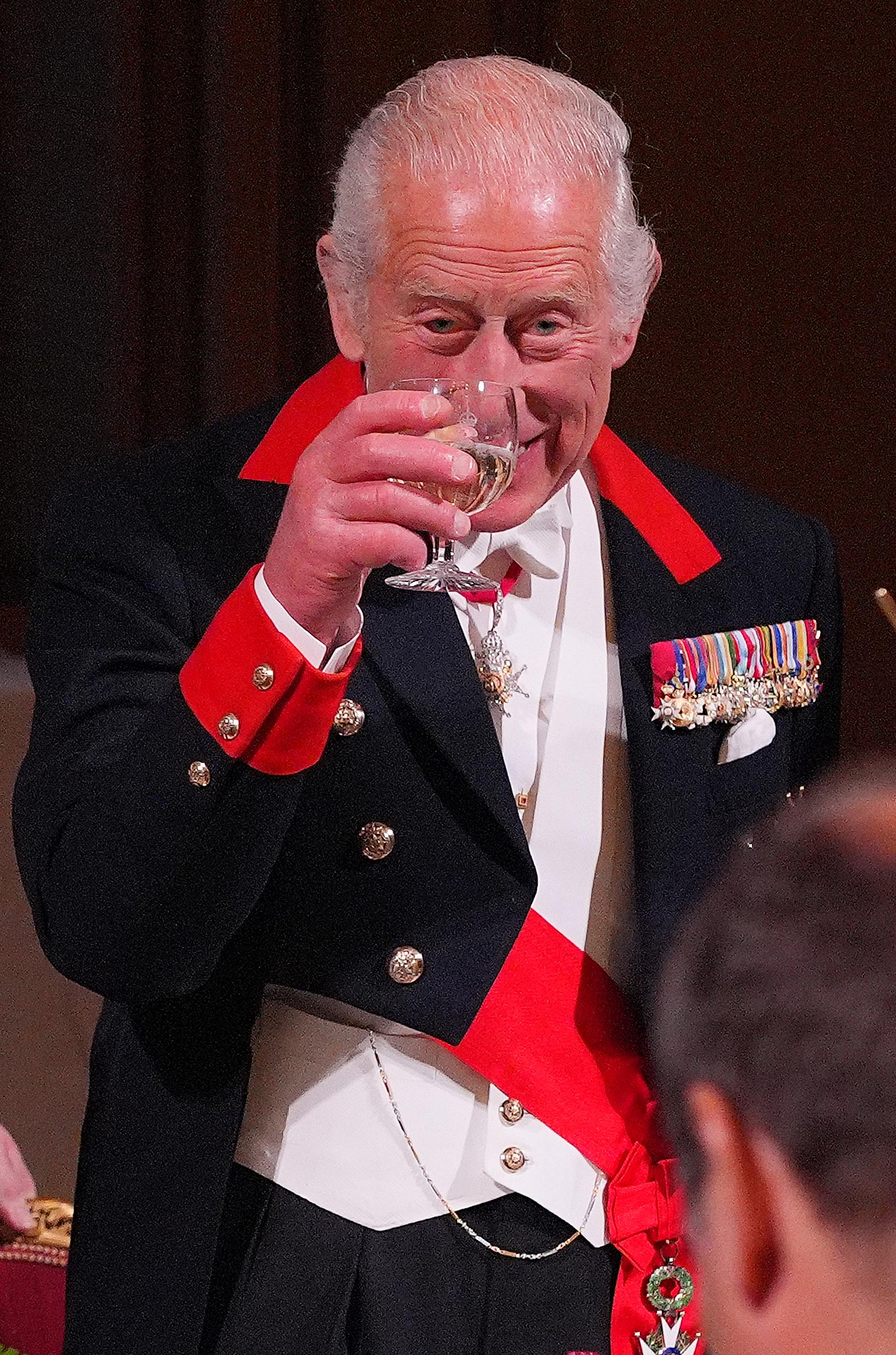 King Charles III raising his wine glass for a toast during the State Banquet for Emmanuel and Brigitte Macron at Windsor Castle on July 8, 2025, in England. | Source: Getty Images