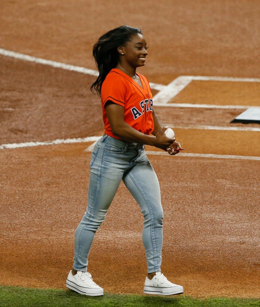 U.S. gymnast Simone Biles throws out the first pitch prior to Game Two of the 2019 World Series at Minute Maid Park | Photo: Getty Images