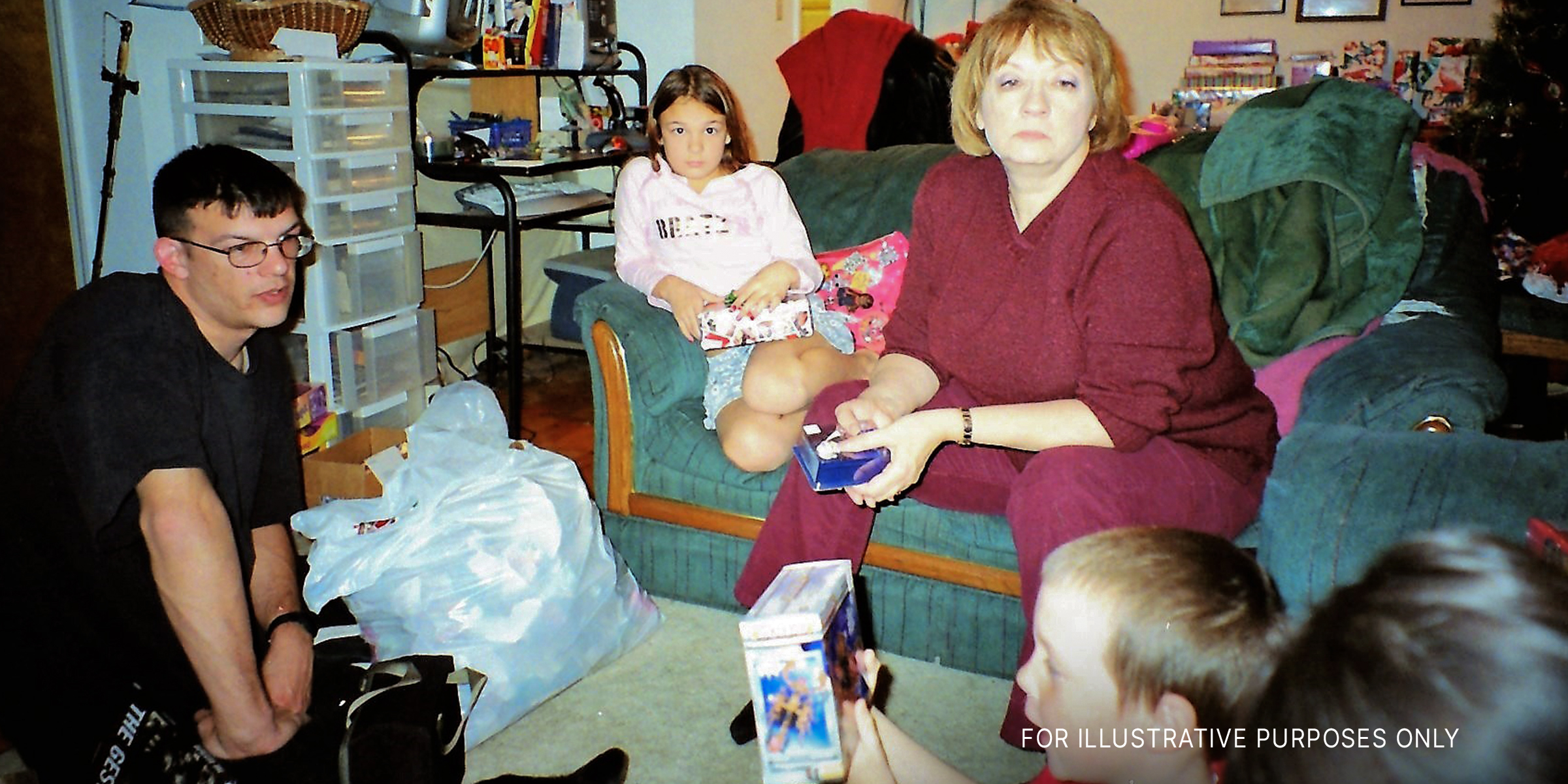 An elderly woman and her son watching their children open Christmas presents | Source: flickr.com/Stabbur's Master/CC BY-SA 2.0