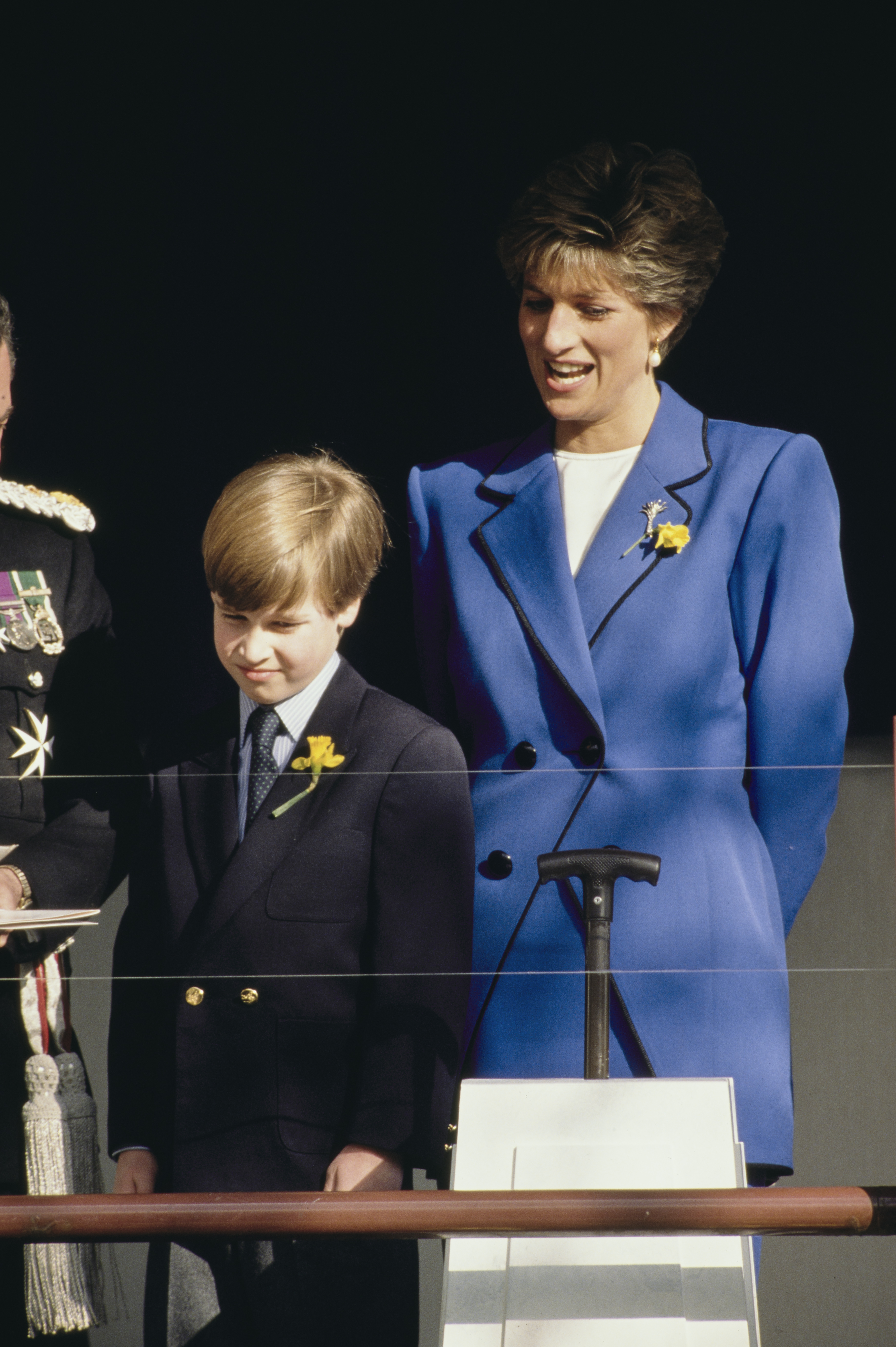 A young Prince William stood beside his mother, Diana, Princess of Wales, during a public engagement in Cardiff, Wales, on January 1, 1991. Both wore daffodils — the national flower of Wales — pinned to their lapels as they greeted officials, with the late princess beaming proudly as her son took part in the day's formalities.