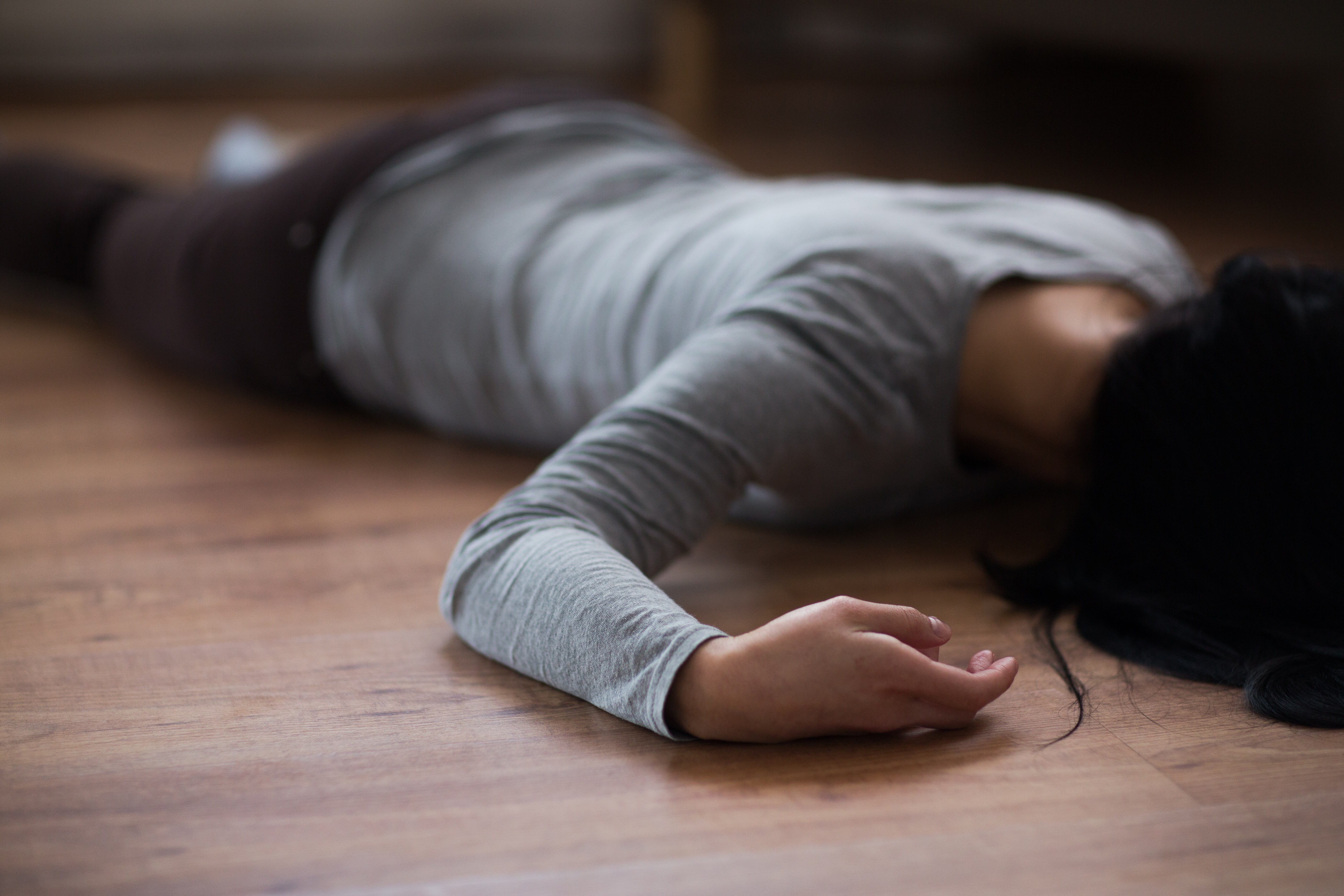Unconscious woman on the ground | Source: Shutterstock.com