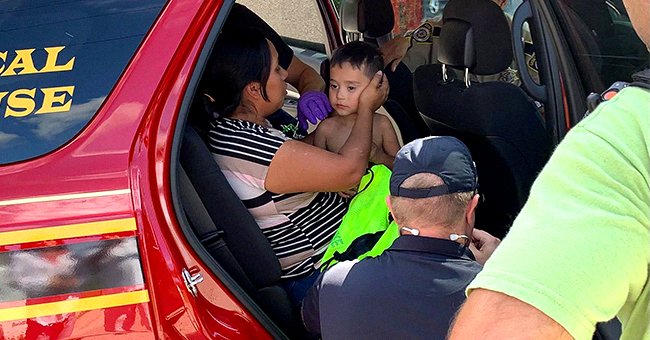 A mother is reunited with her missing son in the back of a police vehicle | Photo: Facebook/EquuSearch