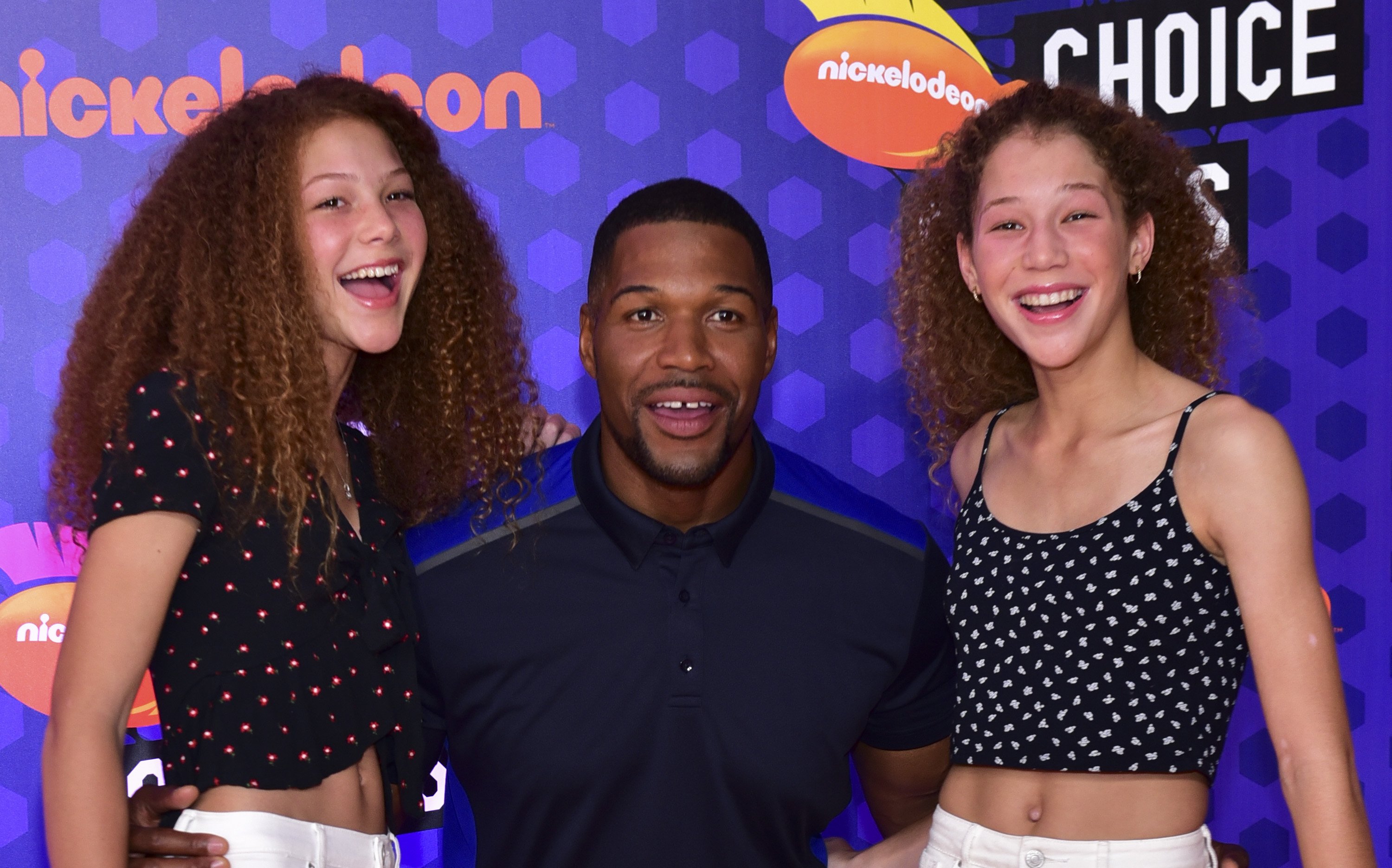 Michael Strahan and his daughters, Isabella Strahan and Sophia Strahan attend Nickelodeon Kids' Choice Sports Awards 2018 at Barker Hangar on July 19, 2018, in Santa Monica, California. | Source: Getty Images
