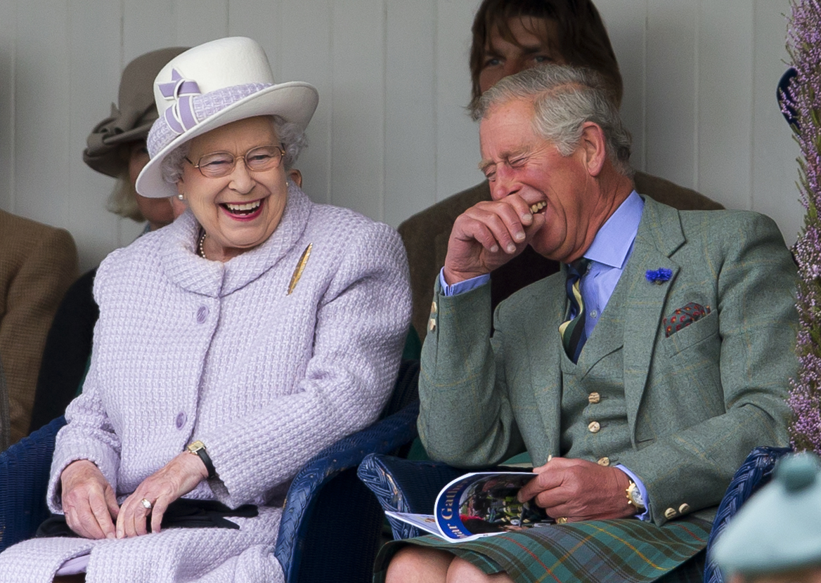 At the Braemar Highland Gathering on 1 September 2012, Queen Elizabeth II and Prince Charles, Prince of Wales share a moment of genuine laughter as they watch a children's sack race unfold, their relaxed expressions and easy rapport offering a rare glimpse into the warmth and humour that defined their relationship beyond royal duty.
