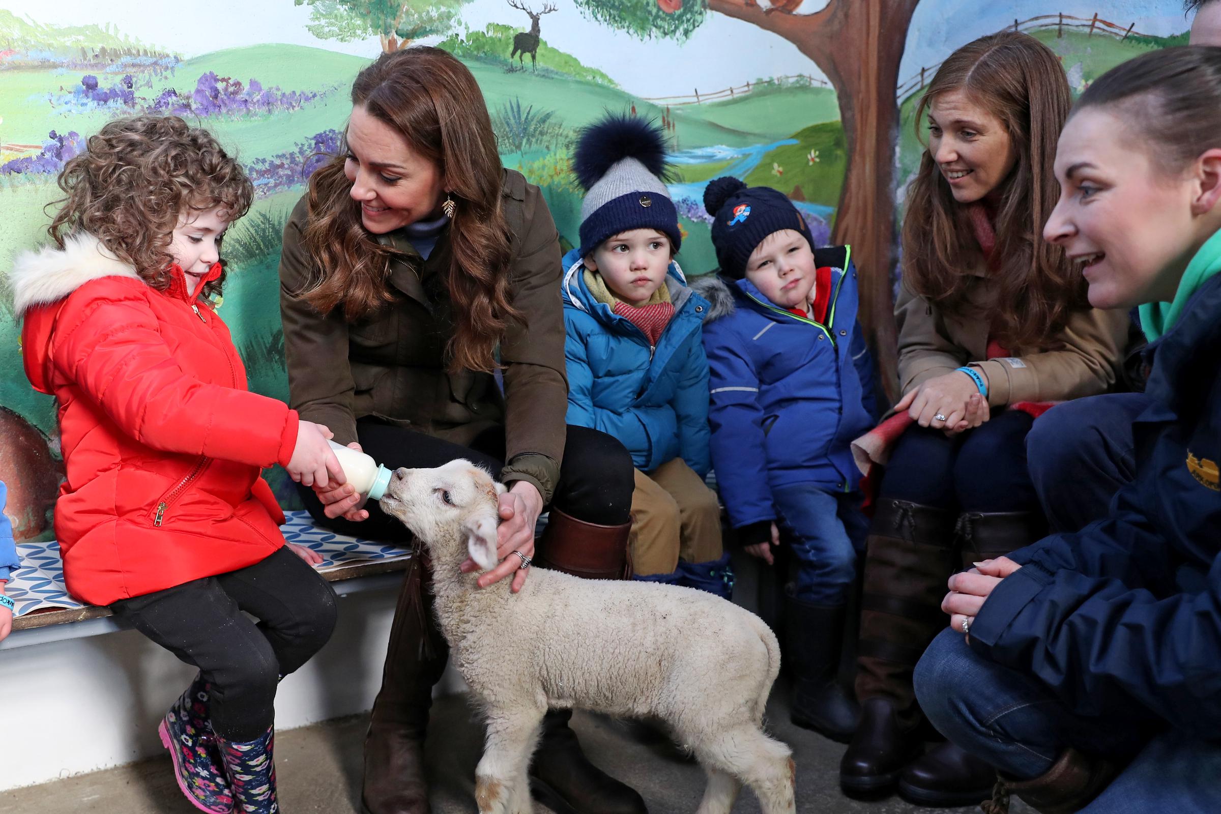 Catherine helps feed a lamb with children from two local nurseries during a visit to The Ark Open Farm on February 12, 2020, in Newtownards, Northern Ireland. | Source: Getty Images