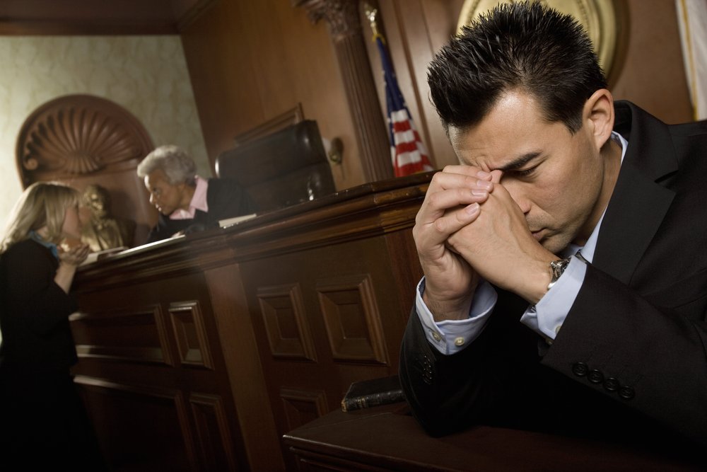 Distressed lawyer in courtroom | Photo: Shutterstock