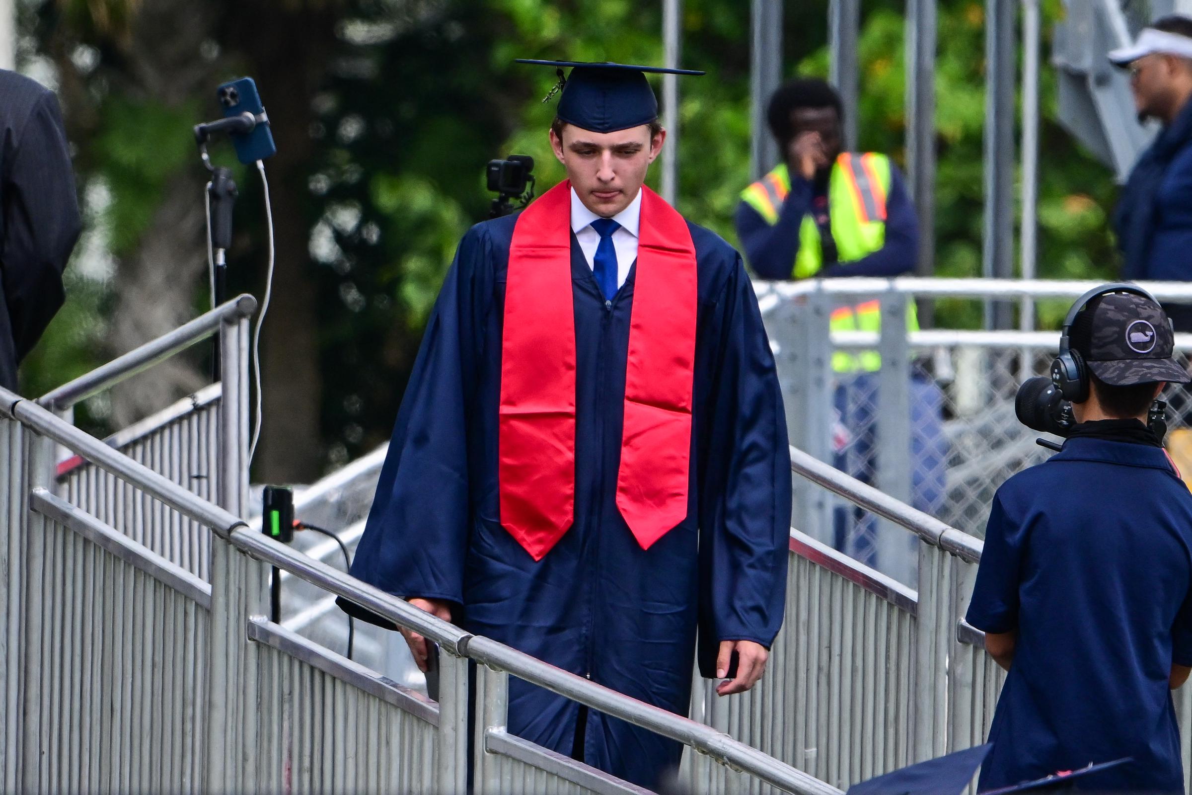 Barron Trump crossed the stage to receive his diploma from Oxbridge Academy in May 2024, one of the family's most closely watched public milestones. His graduation drew both of his parents as well as his grandfather, Viktor Knavs, highlighting the rare occasions when Melania Trump's father appears alongside the family at major events. | Source: Getty Images