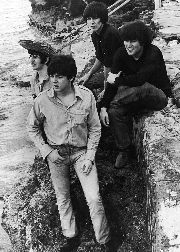 Members of the British rock group The Beatles pose on a sea wall during the filming of their movie, 'Help!,' Nassau, Bahamas, February 26, 1965. | Getty Images / Global Images Ukraine Members of the British rock group The Beatles pose on a sea wall during the filming of their movie, 'Help!,' Nassau, Bahamas, February 26, 1965. | Getty Images / Global Images Ukraine