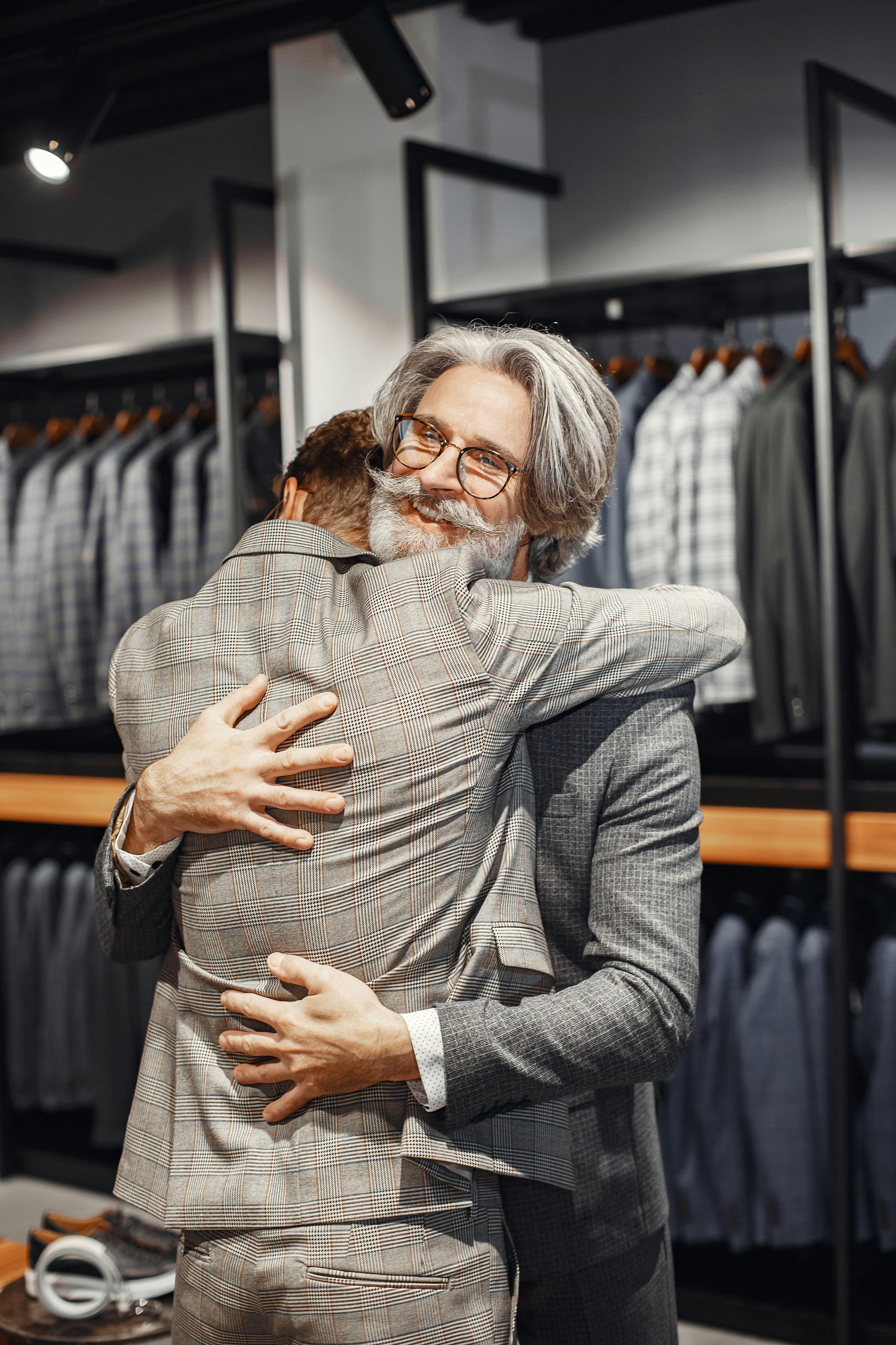 An elderly man hugging a young man | Source: Pexels